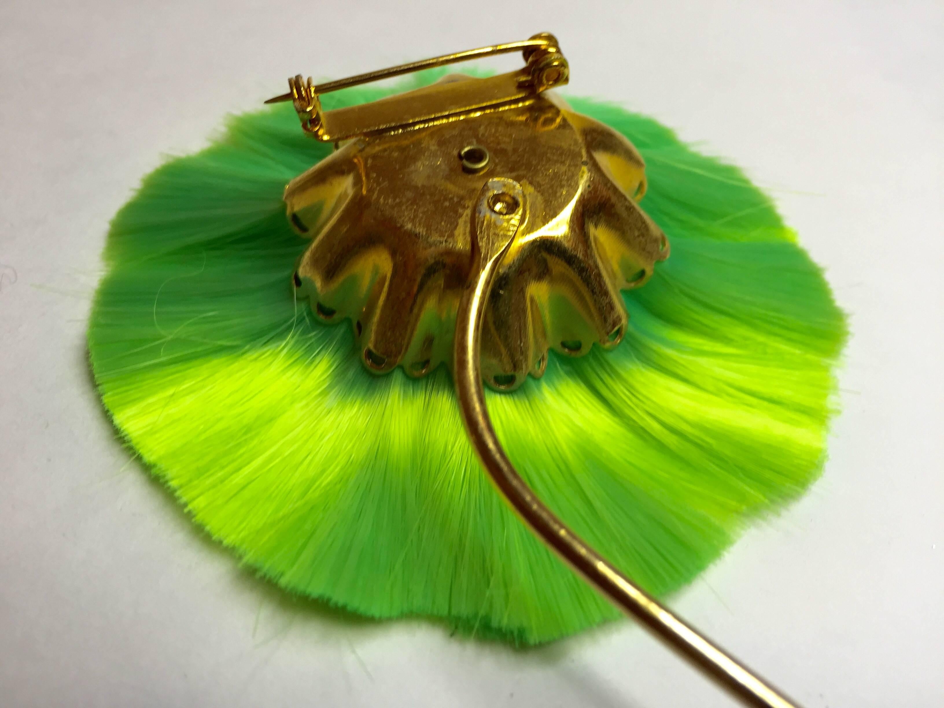 This utterly novel and highly amusing fiber flower whiskbroom stylee pin is by designer Hattie Carnegie. This size is approximately 2 inches across, the blossom, with a three inch long extra stem making for a rather large and important statement