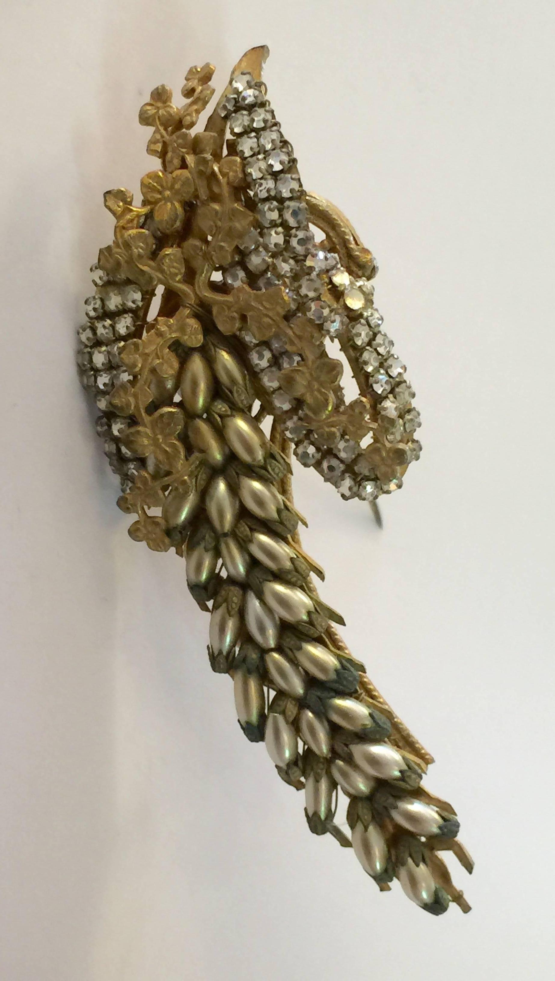 Among the loveliest pearl and goldtone Miriam Haskell brooch pins ever, this floral figural delphinium brooch makes a figural statement ..large ,elongated and detailed--just like the exquisite tall form of the delphinium blossom.  Most floral shapes