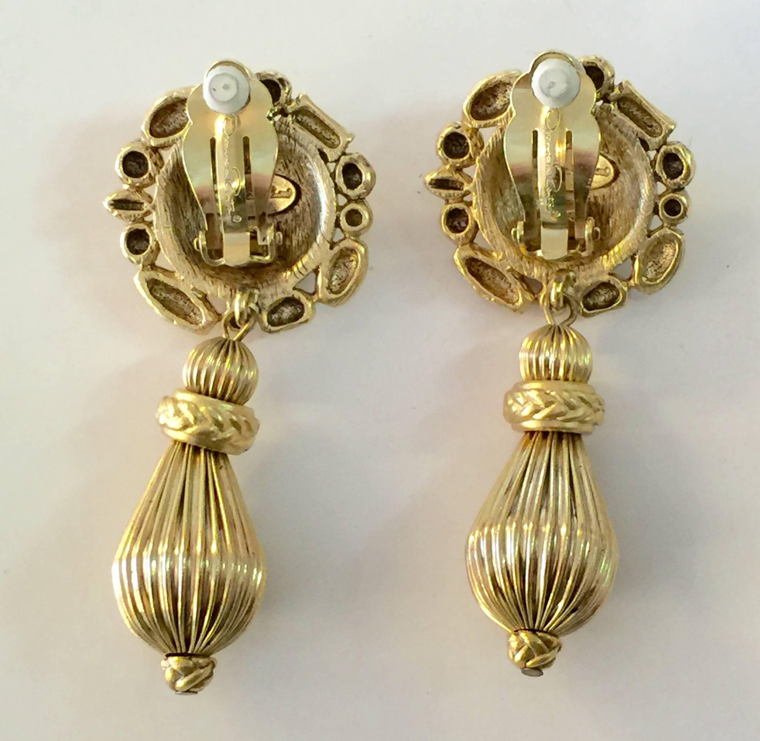 These are classic 80's ODLR, and and are highly wearable, tailored clip on drop earrings. The button top disc is constructed with wired beads and a hammered domed goldtone cabochon of metal, 1