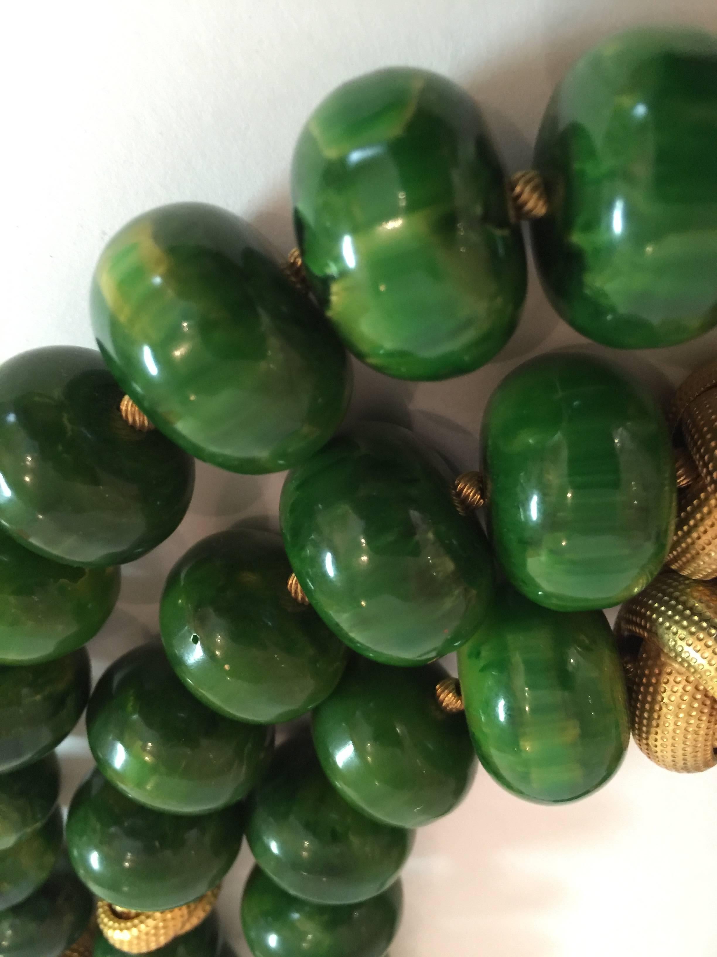 This 1950s CASTLECLIFF faux jade graduated 3 strand Bakelite and Goldtone Knot barrel Bead Necklace is part of a series by this well known costume jewelry company utilizing 1930s old stock beads ,and utilizing them in a more 1950s period size and