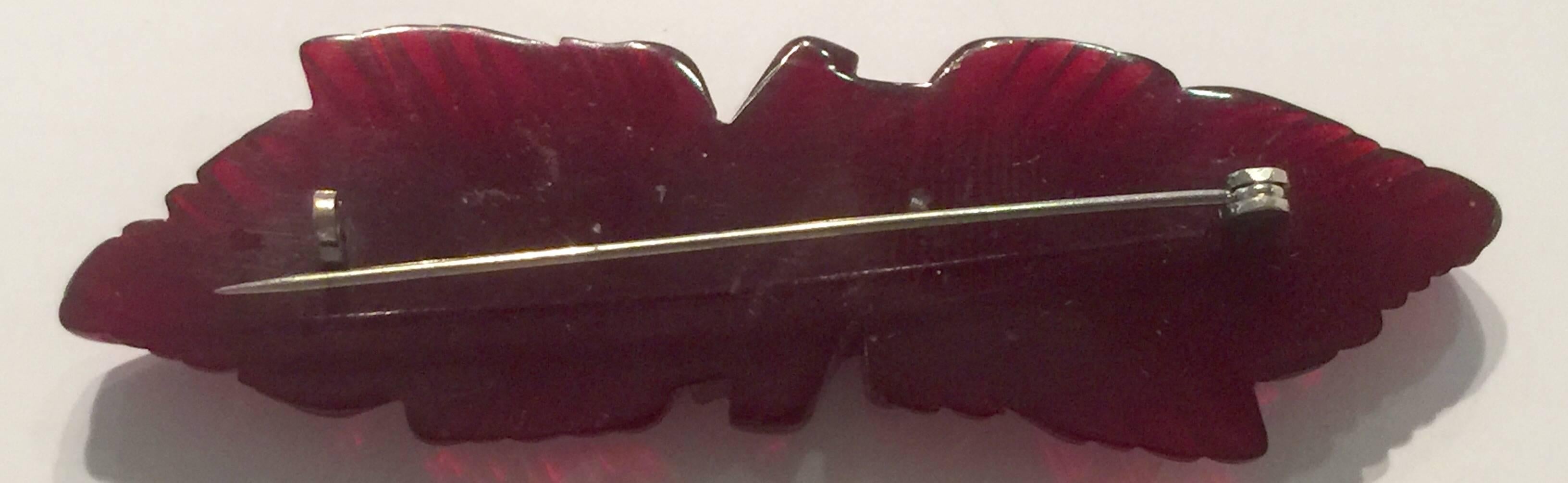 A classic 1930s Translucent  Maroon Bakelite Carved Leaf bar Pin brooch is rich claret color and has edges which reveal great light and translucence. Approximately 2.25