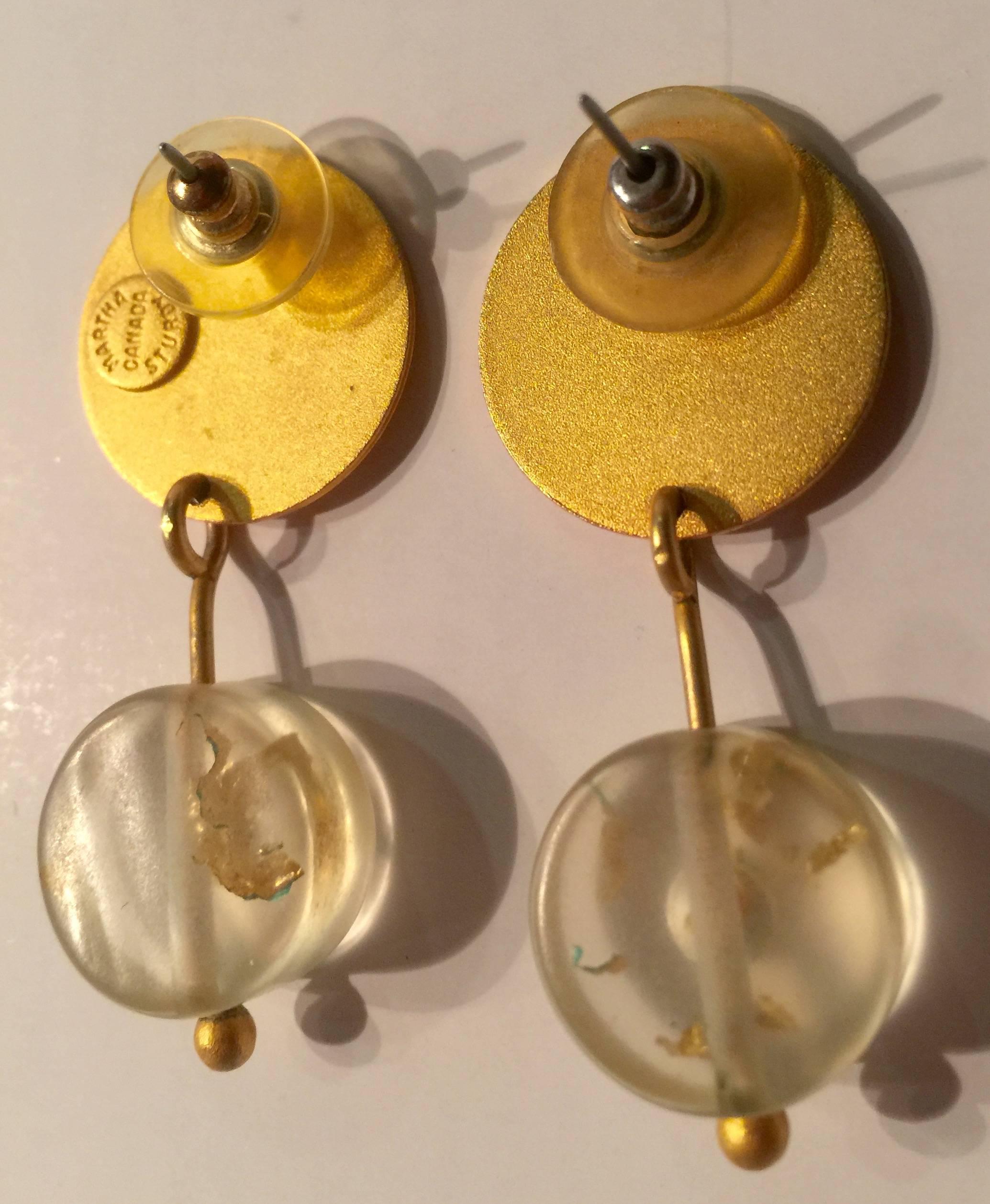 Lovely 1980s MARTHA STURDY VANCOUVER Goldtone and Gold flake Resin Drop Earrings include pierced back hardware. The gold tone of these earrings ia a matte form, and the upper disc is approximately .65 in diameter Suspended from those discs are
