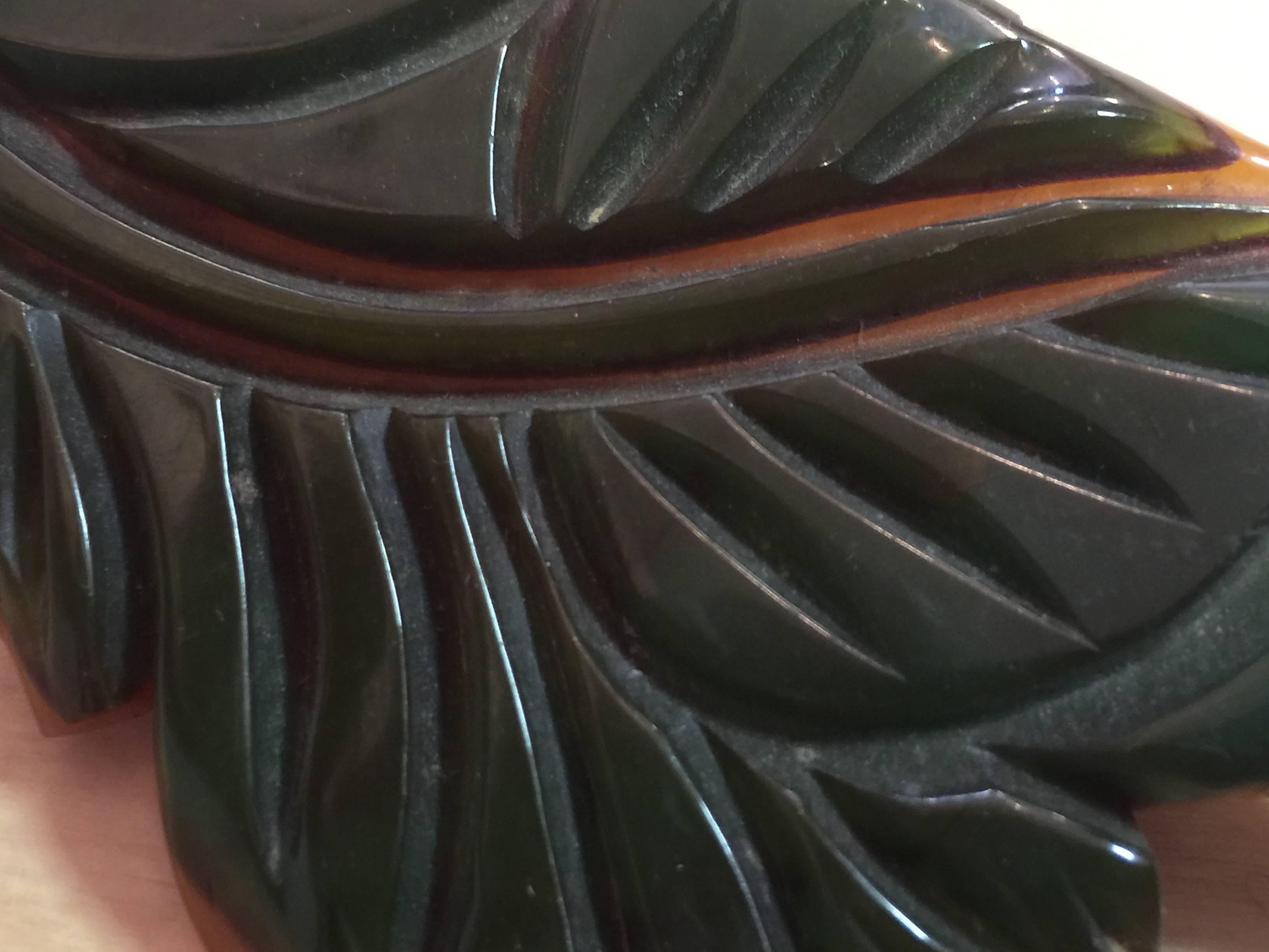 This 1930s Two-tone Cast Carved Bakelite 2-color Brooch Pin in leaf form is a laminated and cast carved piece of bakelite jewelry. This type of decorating technique is among the most sought after and popular in bakelite bangle collecting circles, as