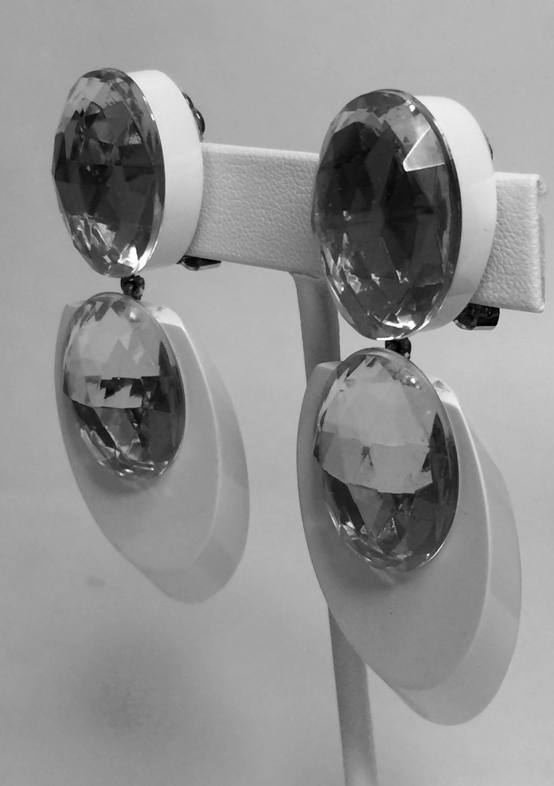 These ACRI-GEMS acrylic and rhinestone clip on drop earrings by Judith Hendler are of the late 1970's early 1980's era. The oval disc top element is approximately 1