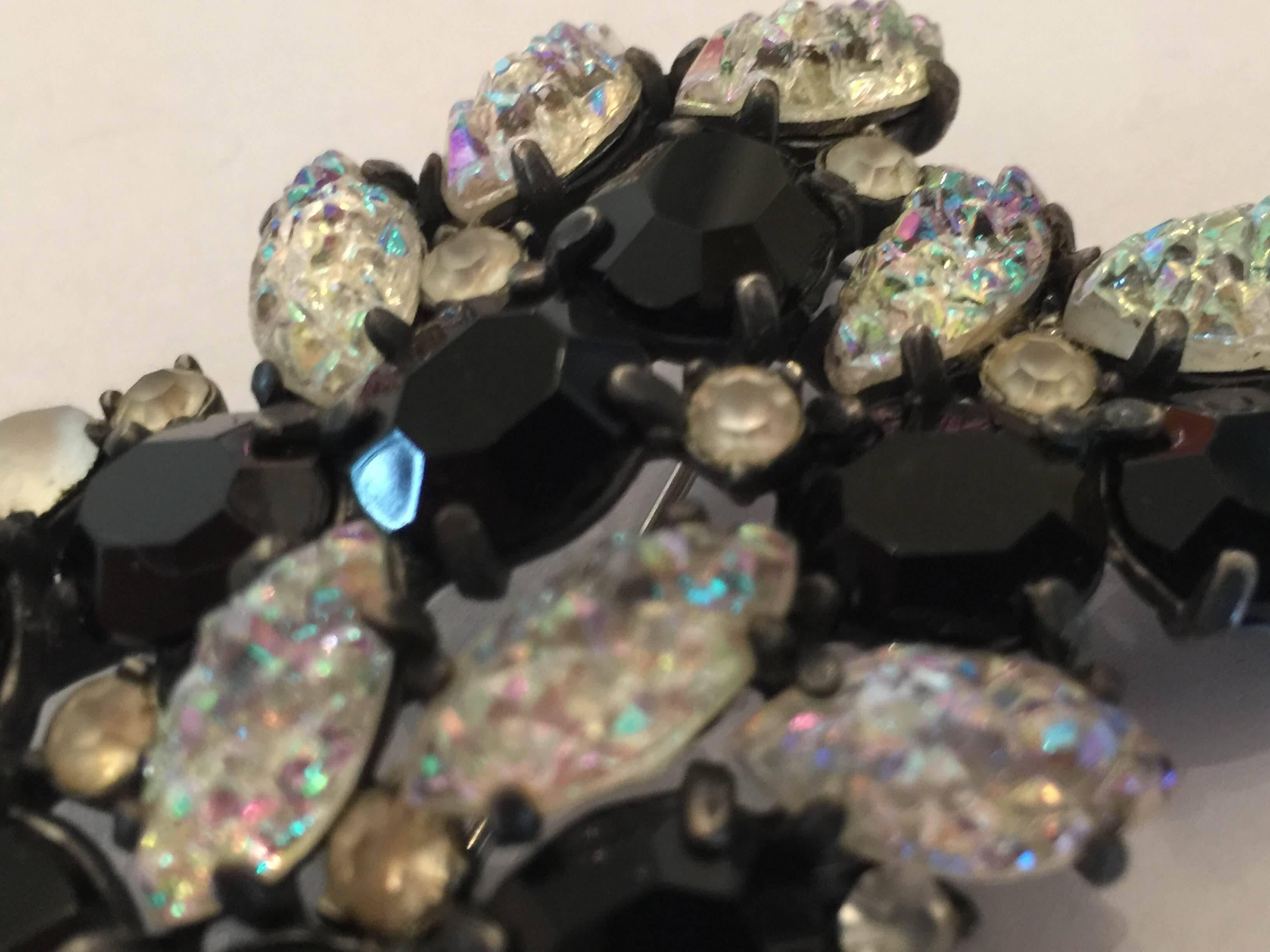An exotic1950s SCHIAPARELLI Lava Rock Borealis and Black Brooch Pin, the exotic clear borealis lava rock stones paired with faceted jet black crystals is dramatic and impactful, indeed. A medium size pin approximately 2.25