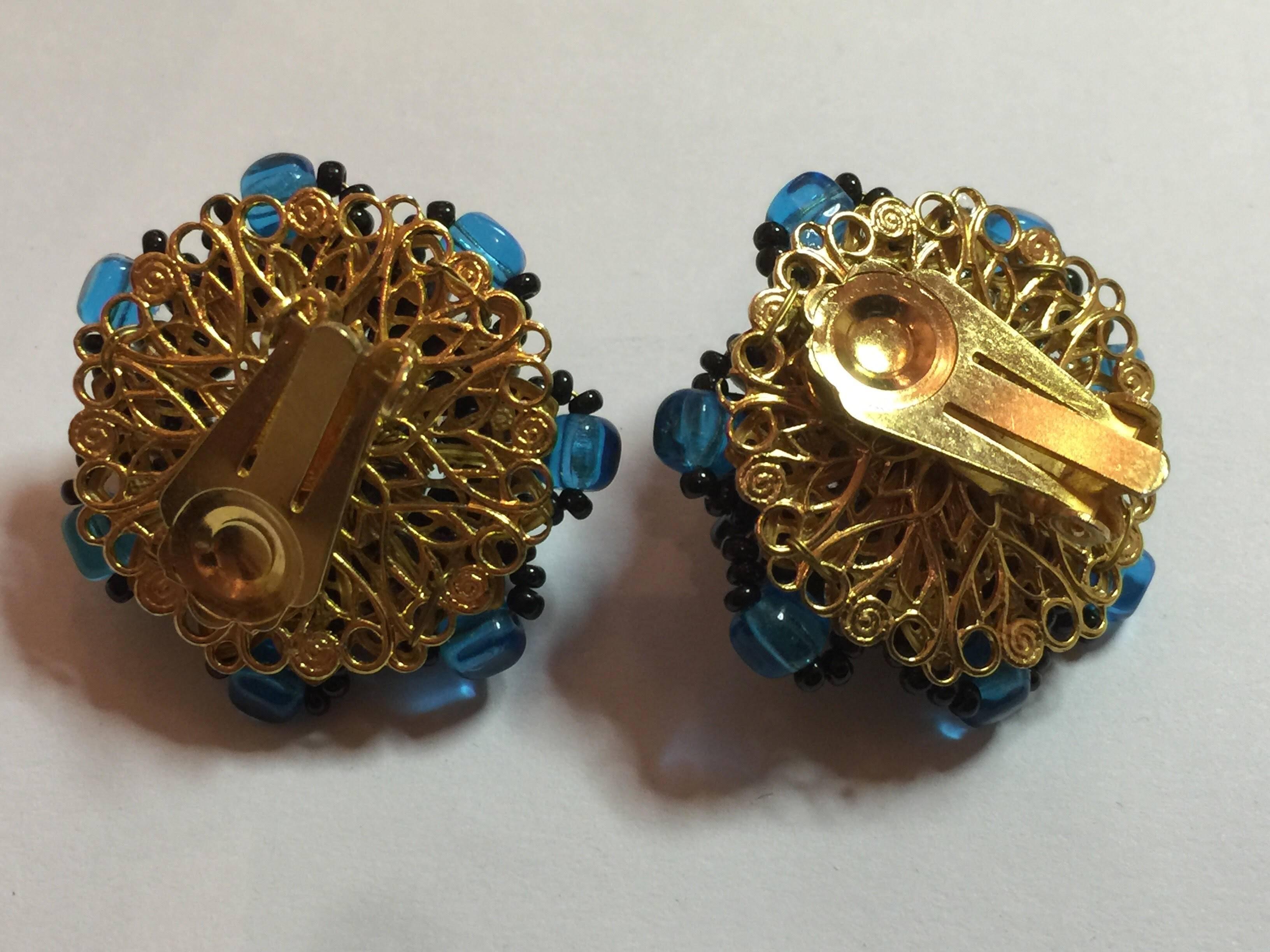 1970s DeLillo Faux Aquamarine Jet Bead and Rhinestone Clip Back Earrings exhibit all the style that the artist and his partner Robert Clark, in their work alongside storied designer Miriam Haskell produced. Influenced by the intricate wiring of seed