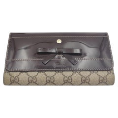 Gucci monogram brown patent leather bow continental wallet