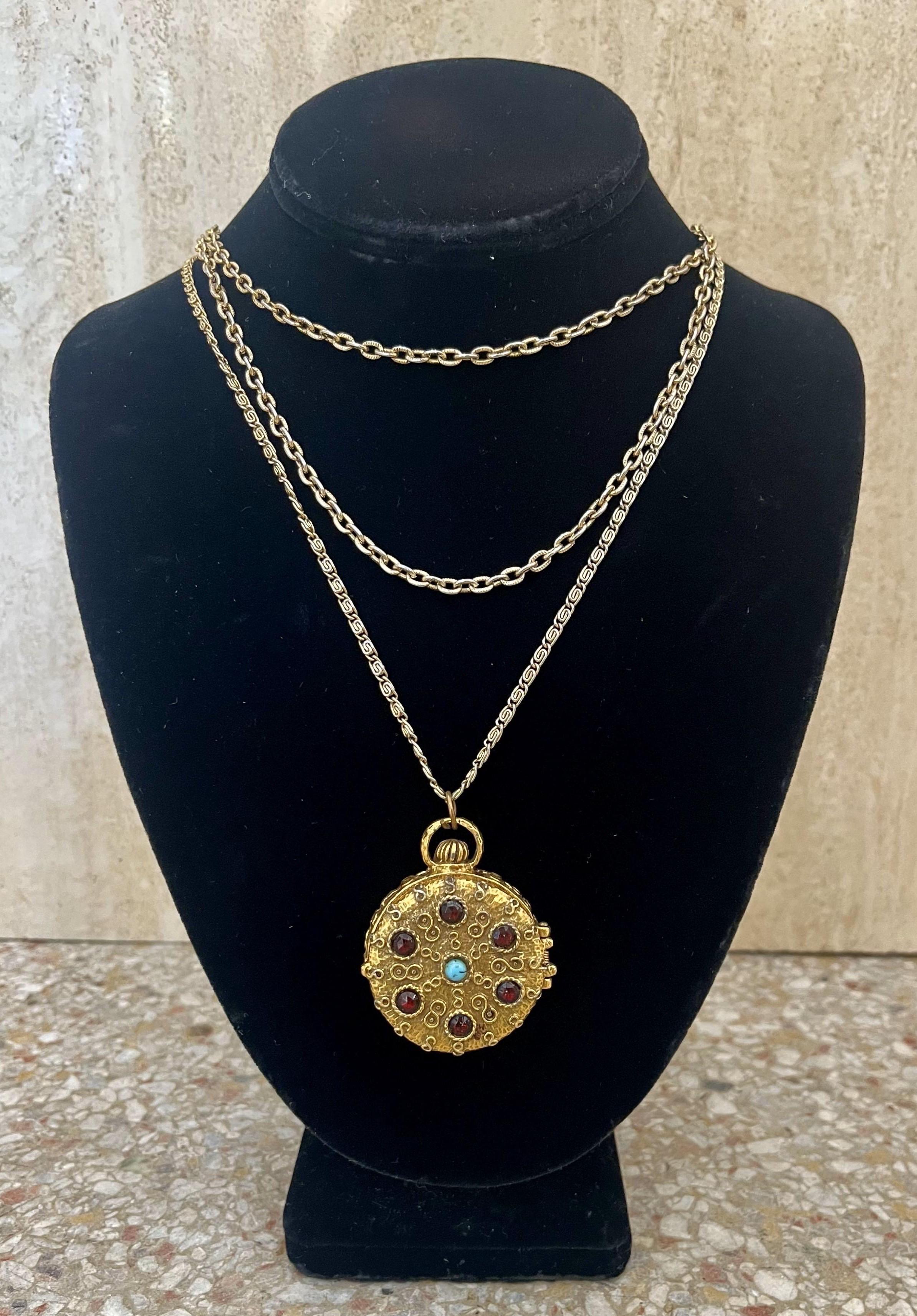 Le collier multibrins Goldette Locket/Pillbox avec turquoise et grenat est un mélange de beauté fonctionnelle avec une touche nostalgique, ce qui en fait une pièce remarquable pour toute collection de bijoux vintage.

Ce collier comporte