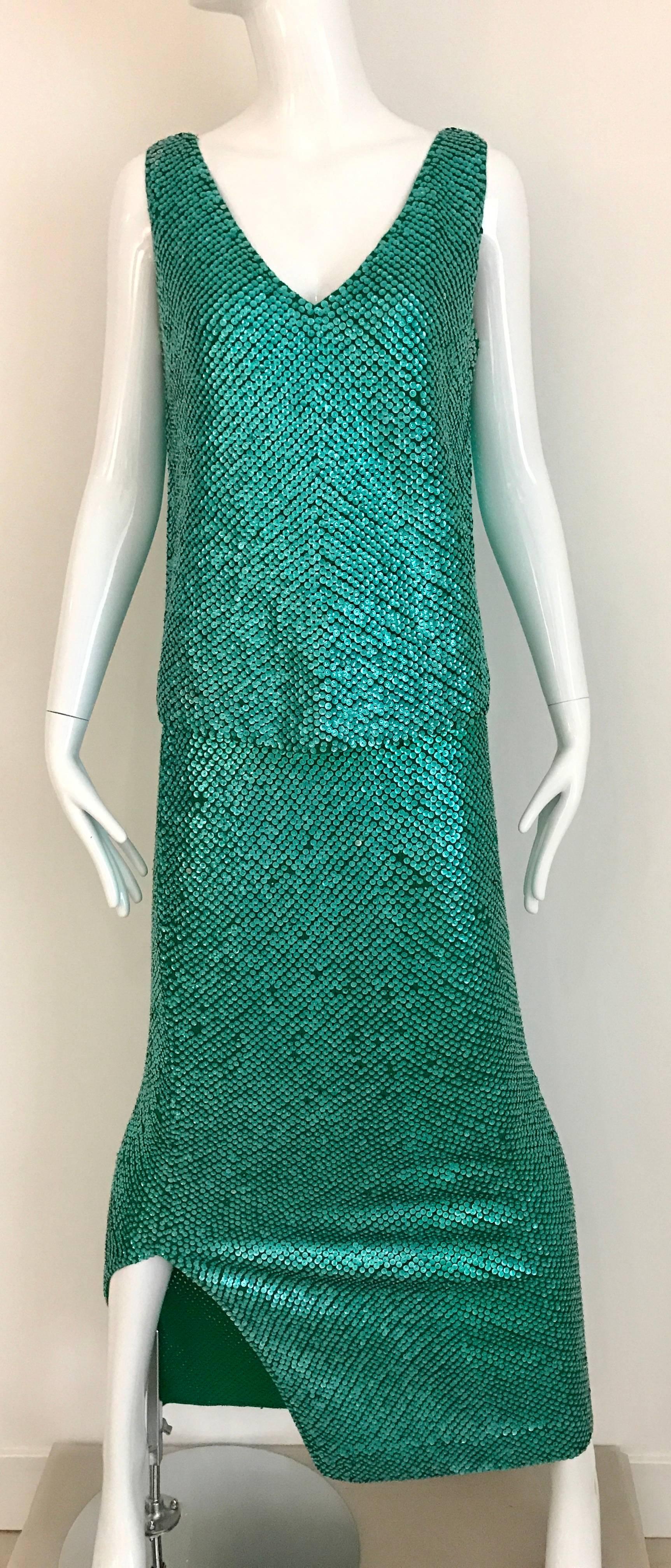 Vintage 60s Gene Shelly Emerald Iridescent Green Sequin Wool Knit Sleeveless top and Maxi Skirt ensemble. V neck sleeveless top zip at the back and Maxi skirt with 10 inch slit on the side. Great ensemble.
Size Medium. Stretchy wool knit.
Top