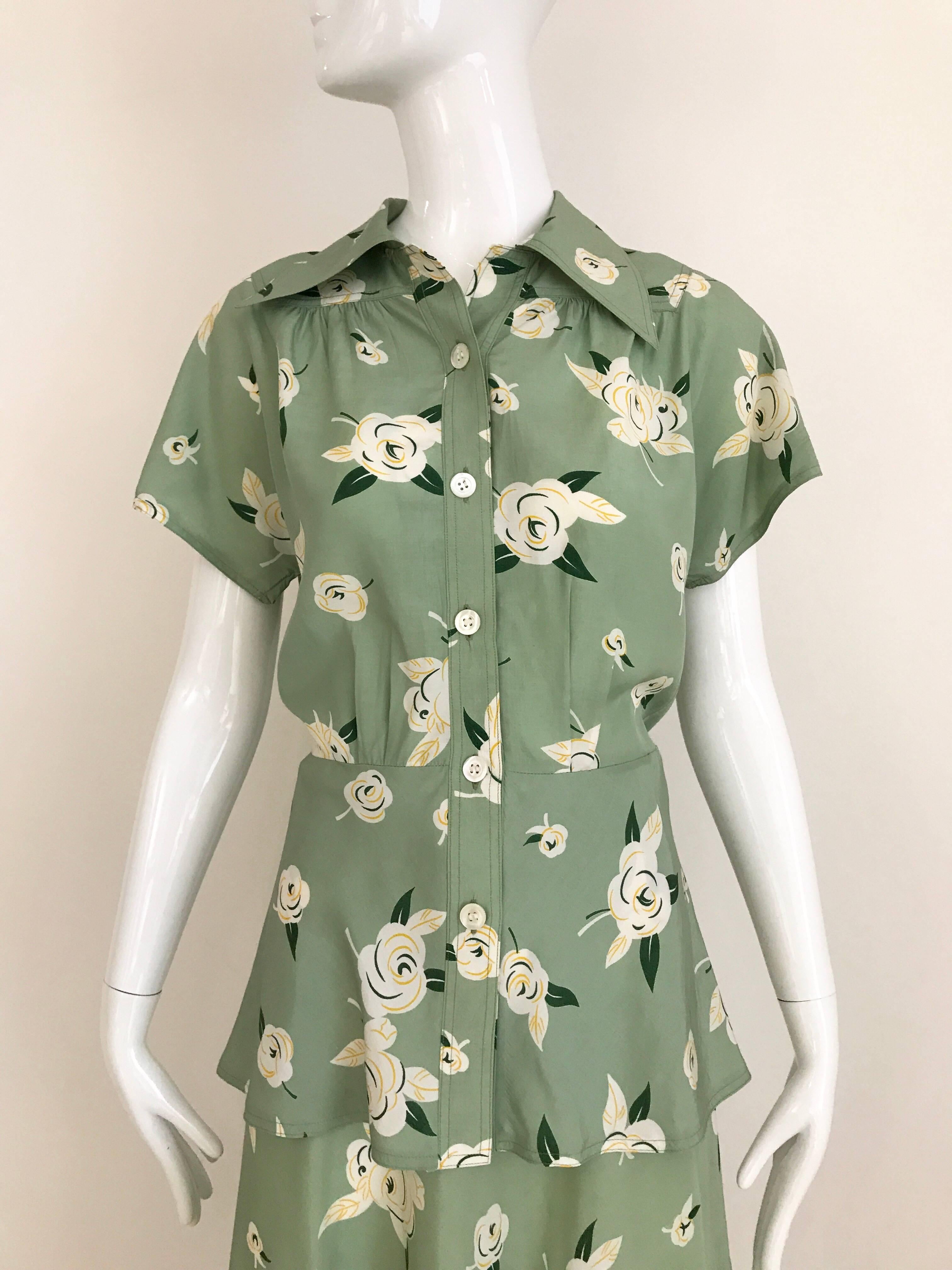 1970s Guy Laroche light green floral print blouse and skirt set. Blouse has slightly peplum style. 
Size: small 4
Blouse measurement: Bust 36 inches/ Blouse Waist 30 inches /Length: 25 inch
Skirt waist: 26 inches, Hip 38 inches/ Skirt length: 30.5