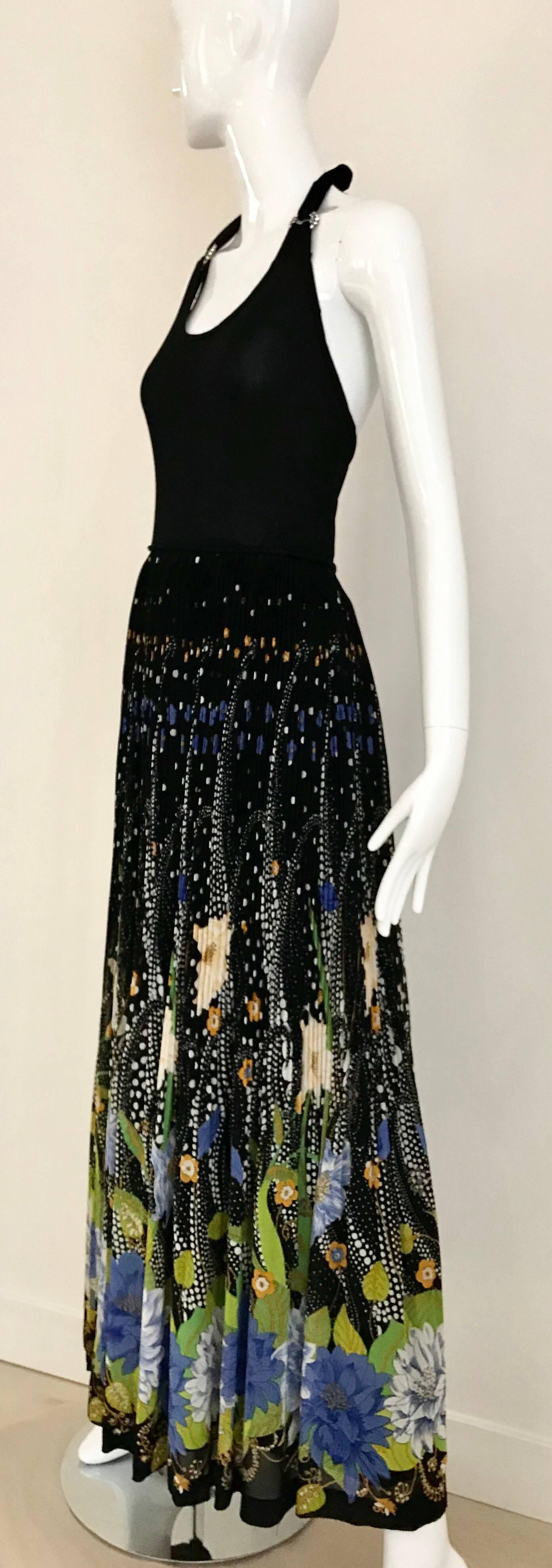 Sexy Black Halter Knit Dress with two buckle rhinestones. Multi color floral print in silk pleated skirt. Zip at the back.  Size 4- Small
Excellent condition

**** This Garment has been professionally Dry Cleaned and Ready to wear.
