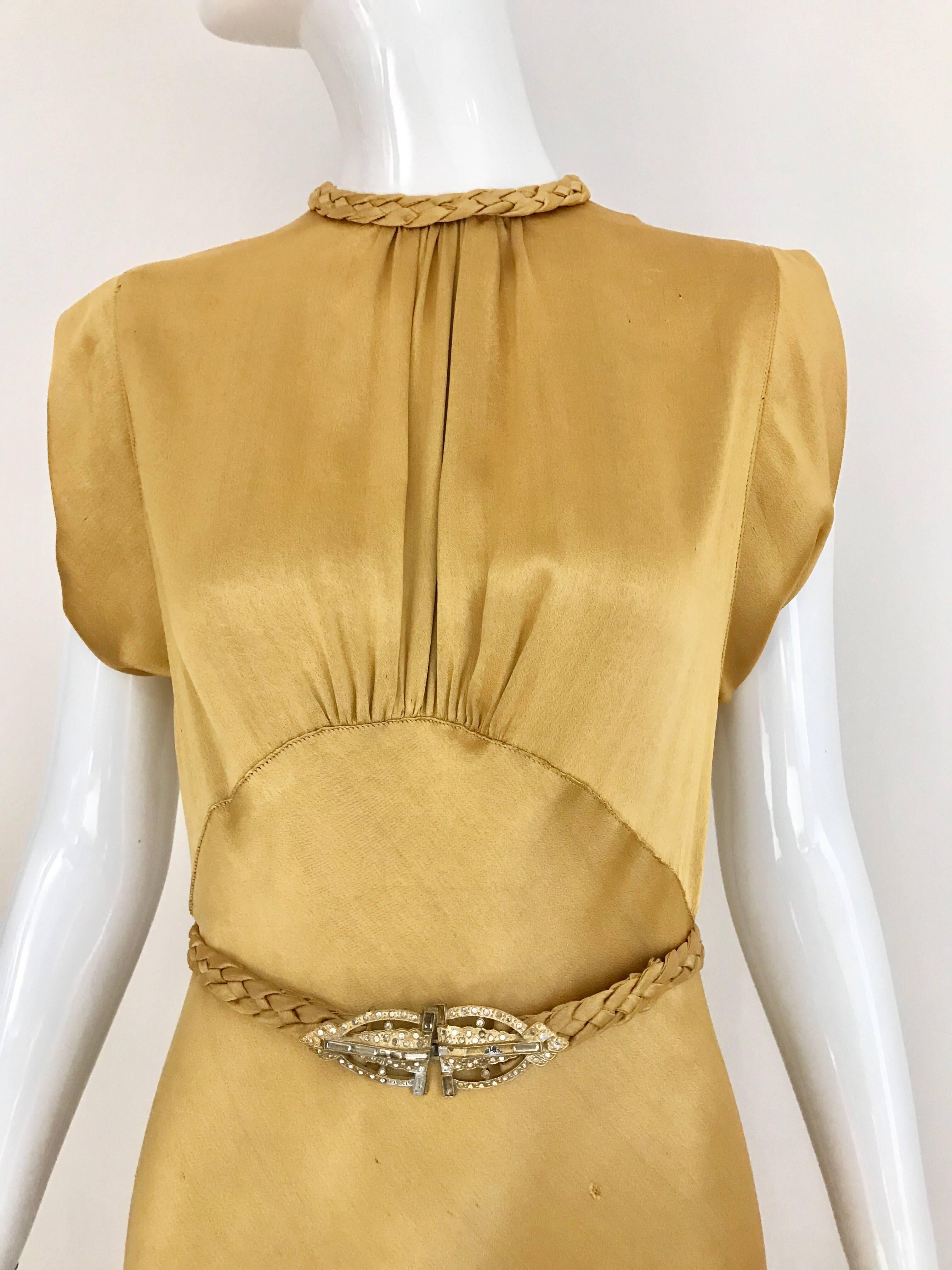 Elegant 1930s Old Hollywood Glamour Gold Satin Gown with Belt. Gown have some tiny holes ( see picture attached) 
Size: 4
Measurement: Bust: 34 inch / Waist: 28 inch/ Length 59 inch
**** This Gown has been professionally Dry Cleaned and Ready to
