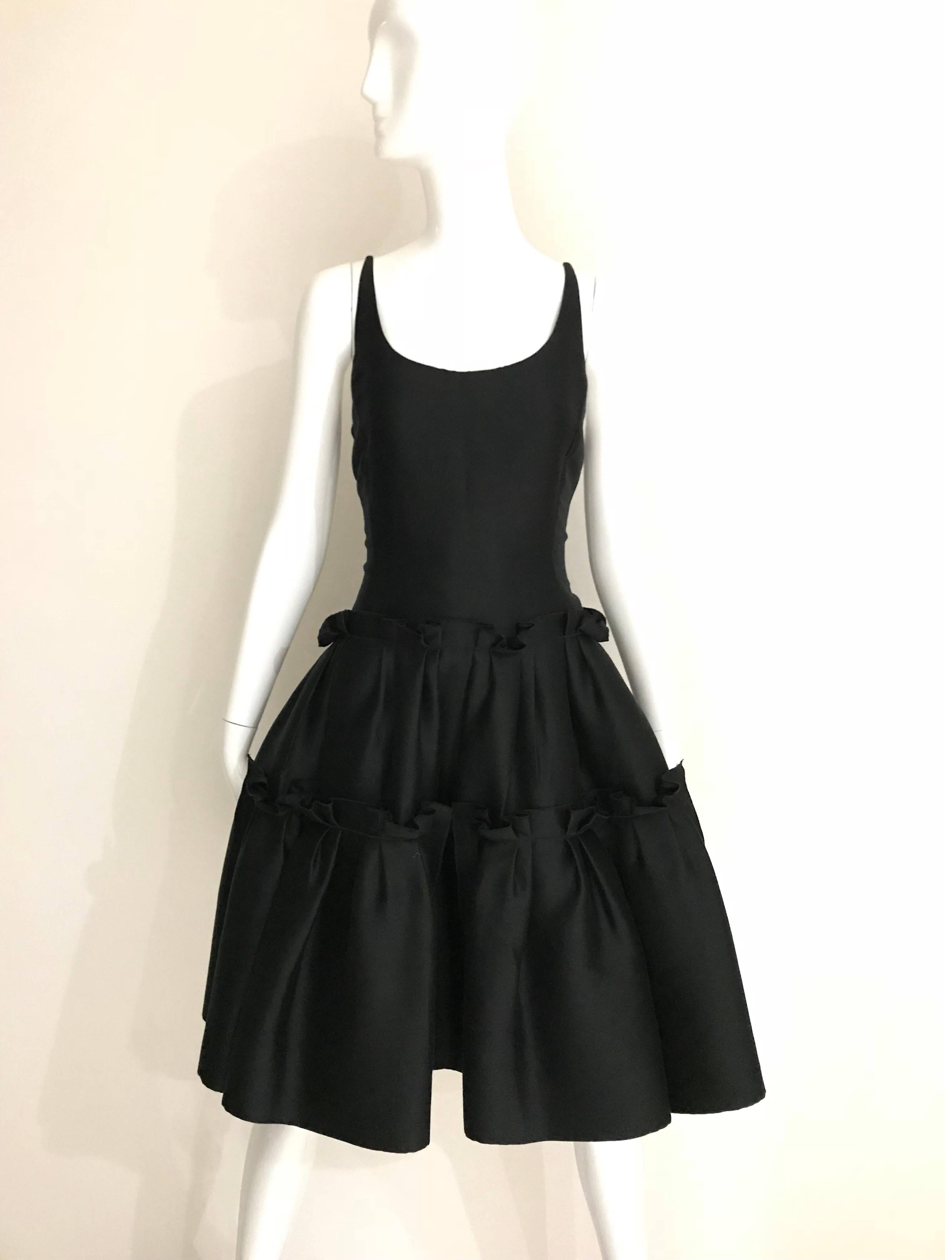 Elegant Oscar De La Renta Black Silk Shantung Cocktail Dress with thin spaghetti strap with tulle flair skirt . Dress zipped at the back. 
Size: 4 / Small 
**** This Garment has been professionally Dry Cleaned and Ready to wear.

