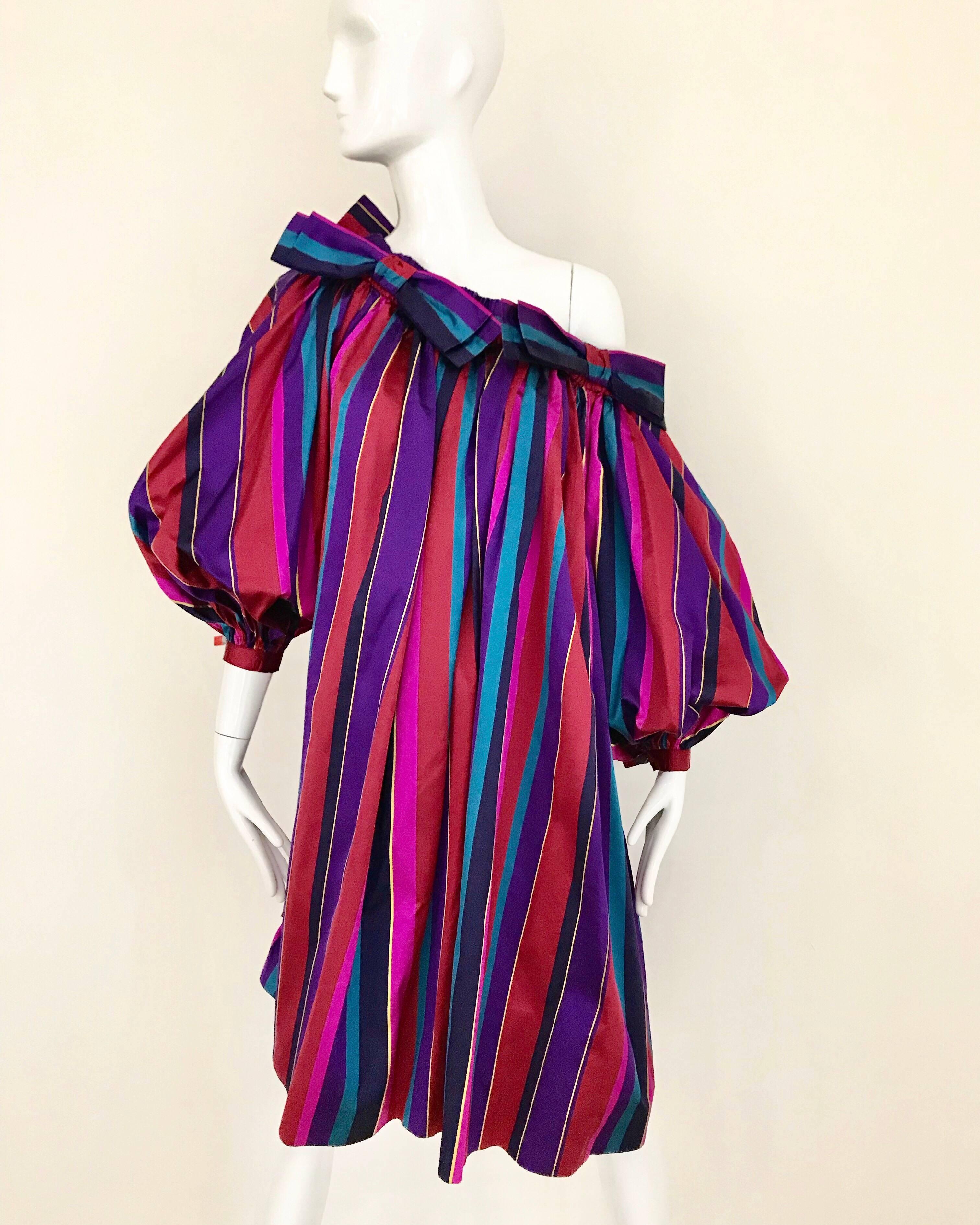 Dramatic and Vibrant vintage late 80s  Yves Saint Laurent rive gauche red, purple and blue striped silk tent dress with 4 bows ( 2 front and 2 back). Dress worn off shoulder.  Sleeves is oversized. This is a tent style dress. 
Fit size small to