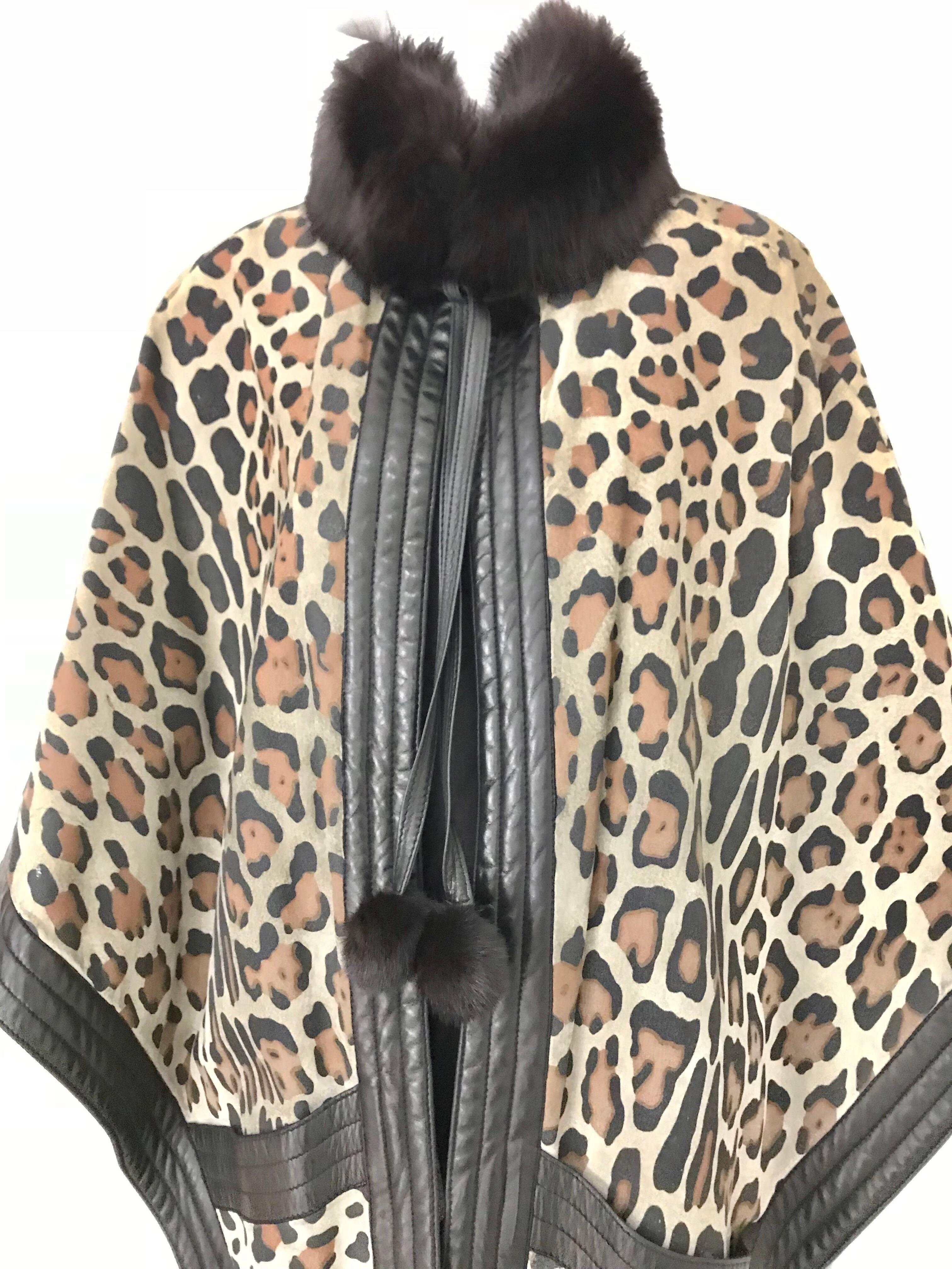 Incredible Vintage Christian Dior Suede Leopard Print Cape lined in wool with fox fur collar and leather tassel. Cape has 2 front pockets and 2 inner pockets.  
Fit all Size.  Small to LARGE  /Mannequin is size 2 ( XS)
