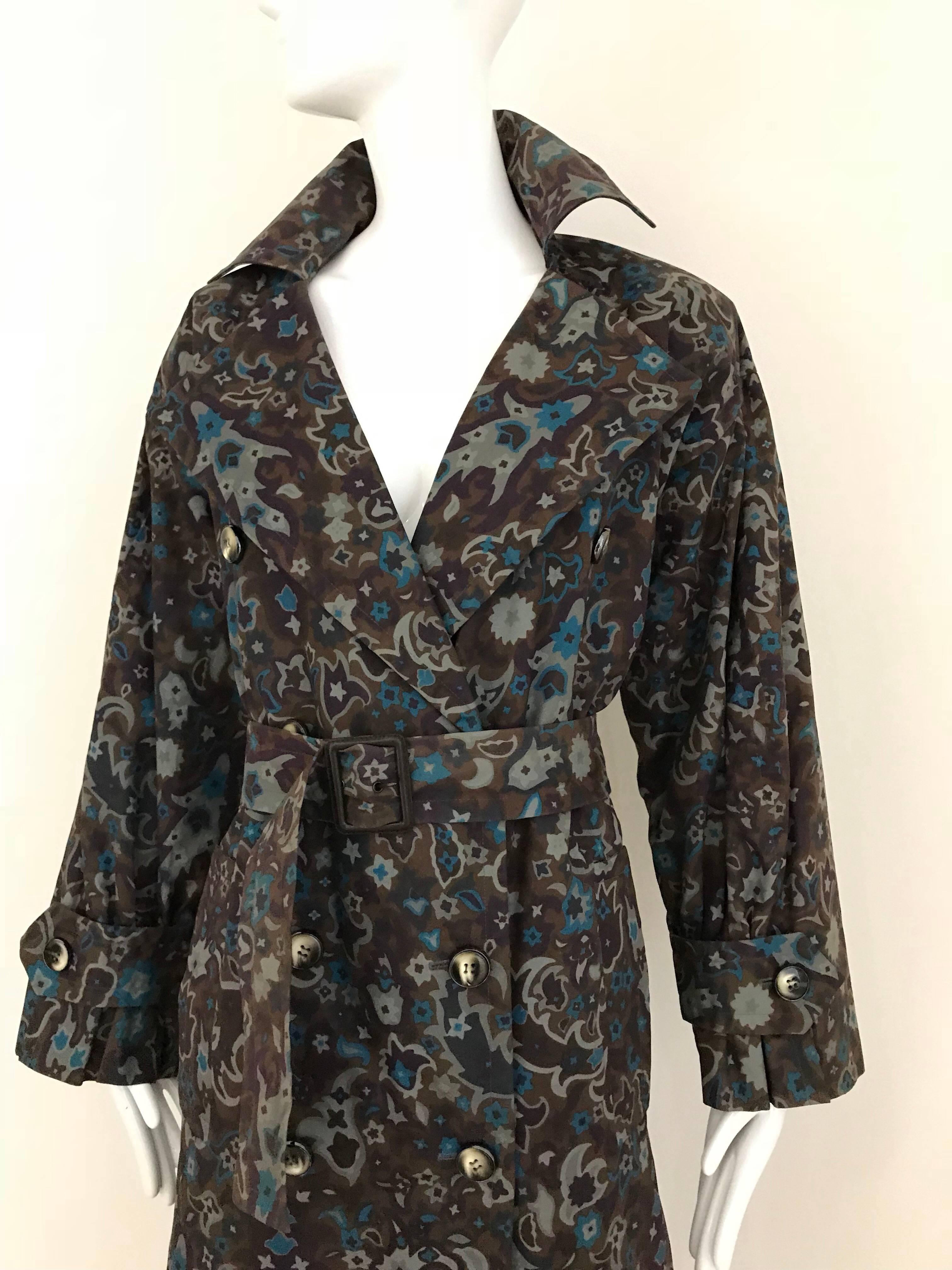 This vintage trench coat by Yves Saint Laurent has the classic good looks we expect from the cut of a trench coat, but the paisley print made of  teal blue and gray, set on a light muted brown background creates a unique look.

This trench would