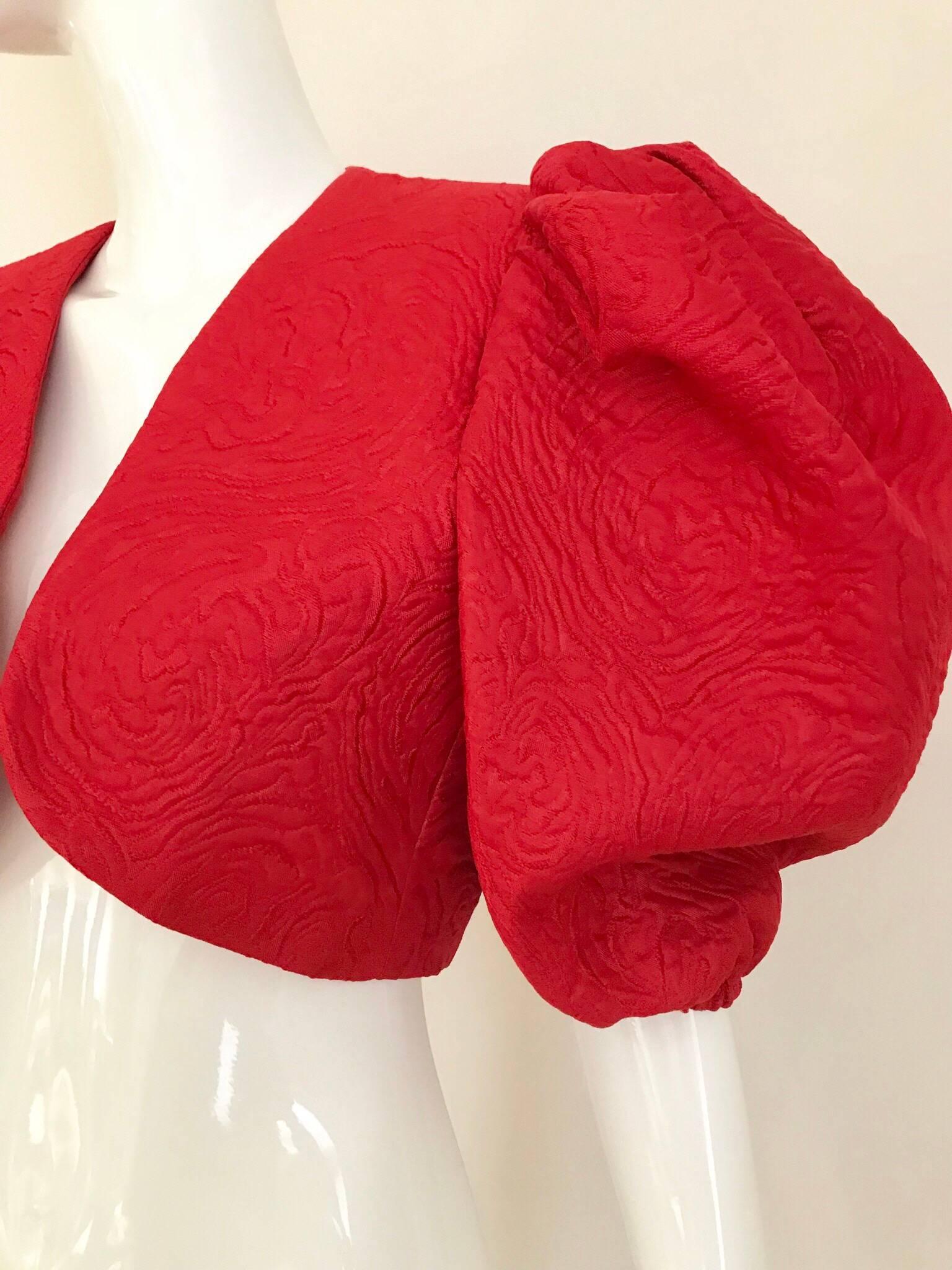 This 80's red Saint Laurent  cropped Bolero jacket can be dressed 
