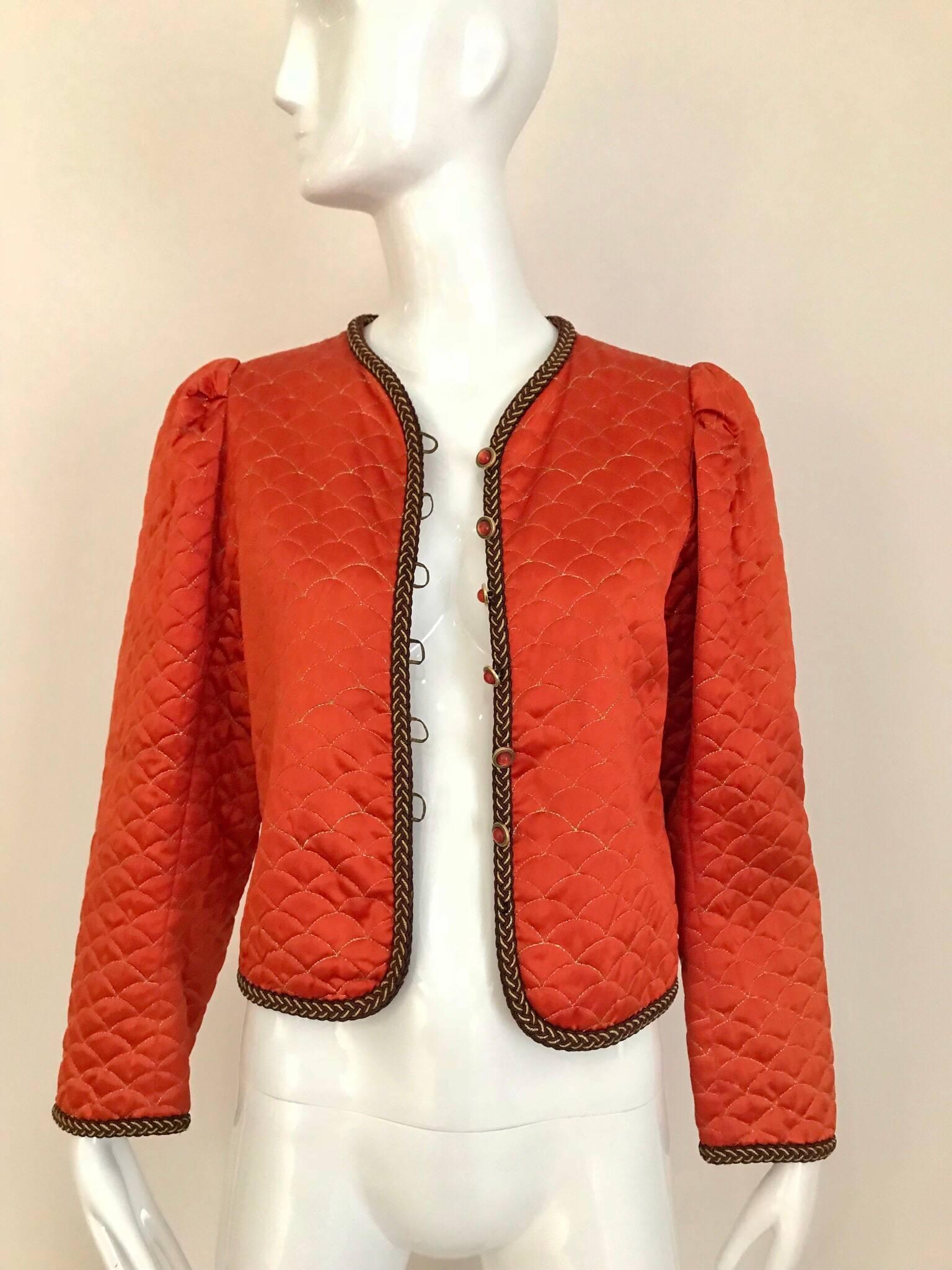 This 80's Mandarin orange silk Saint Laurent jacket is simple but chic! The clam-shell quilted motif is stitched with gold thread and contrasts the Mandarin orange silk fabric very nicely.  The woven braided gold trim is a special touch on this