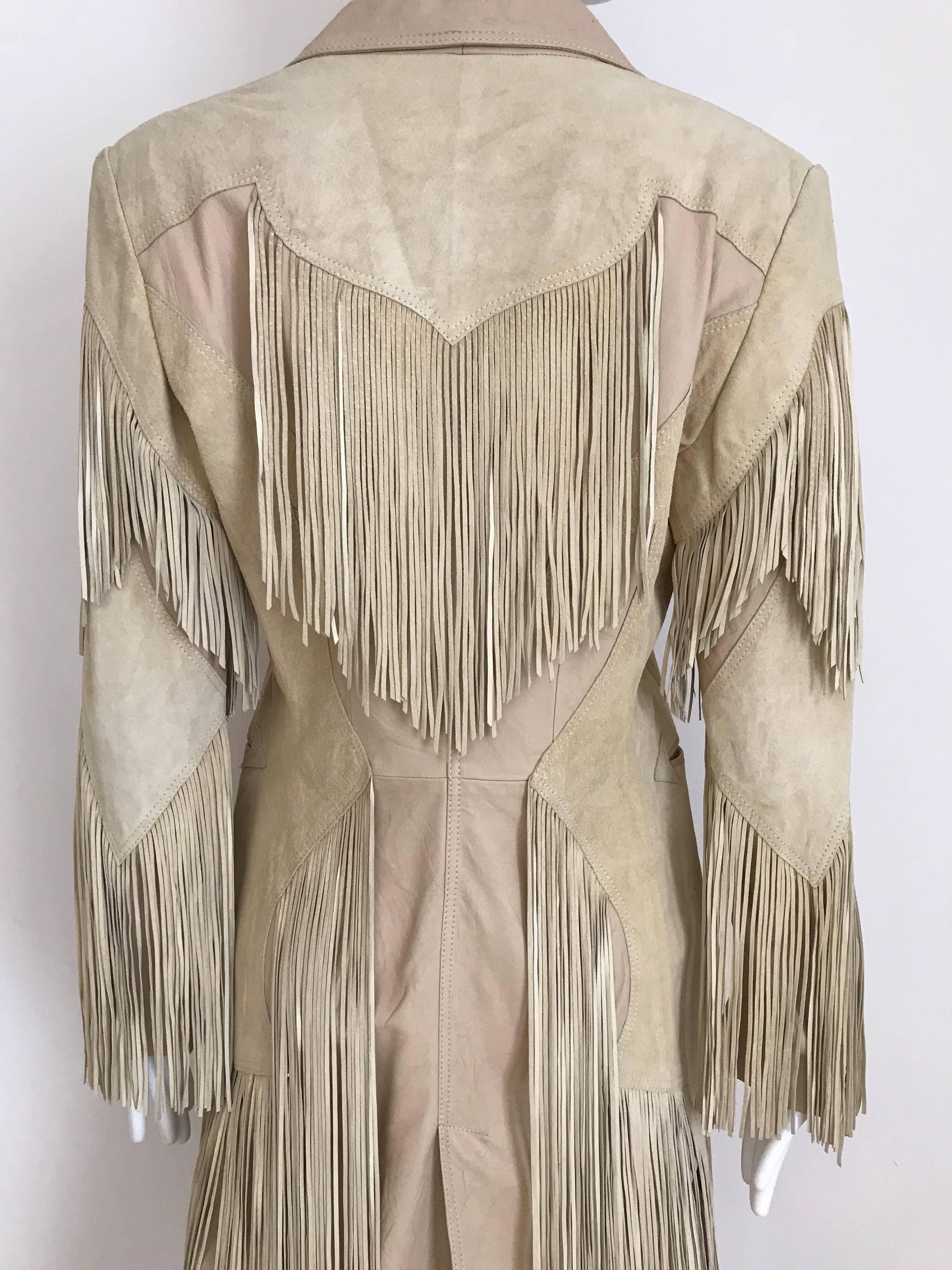 Vintage Versace creme leather and suede coat with fringe and pockets.
Fit size US 6