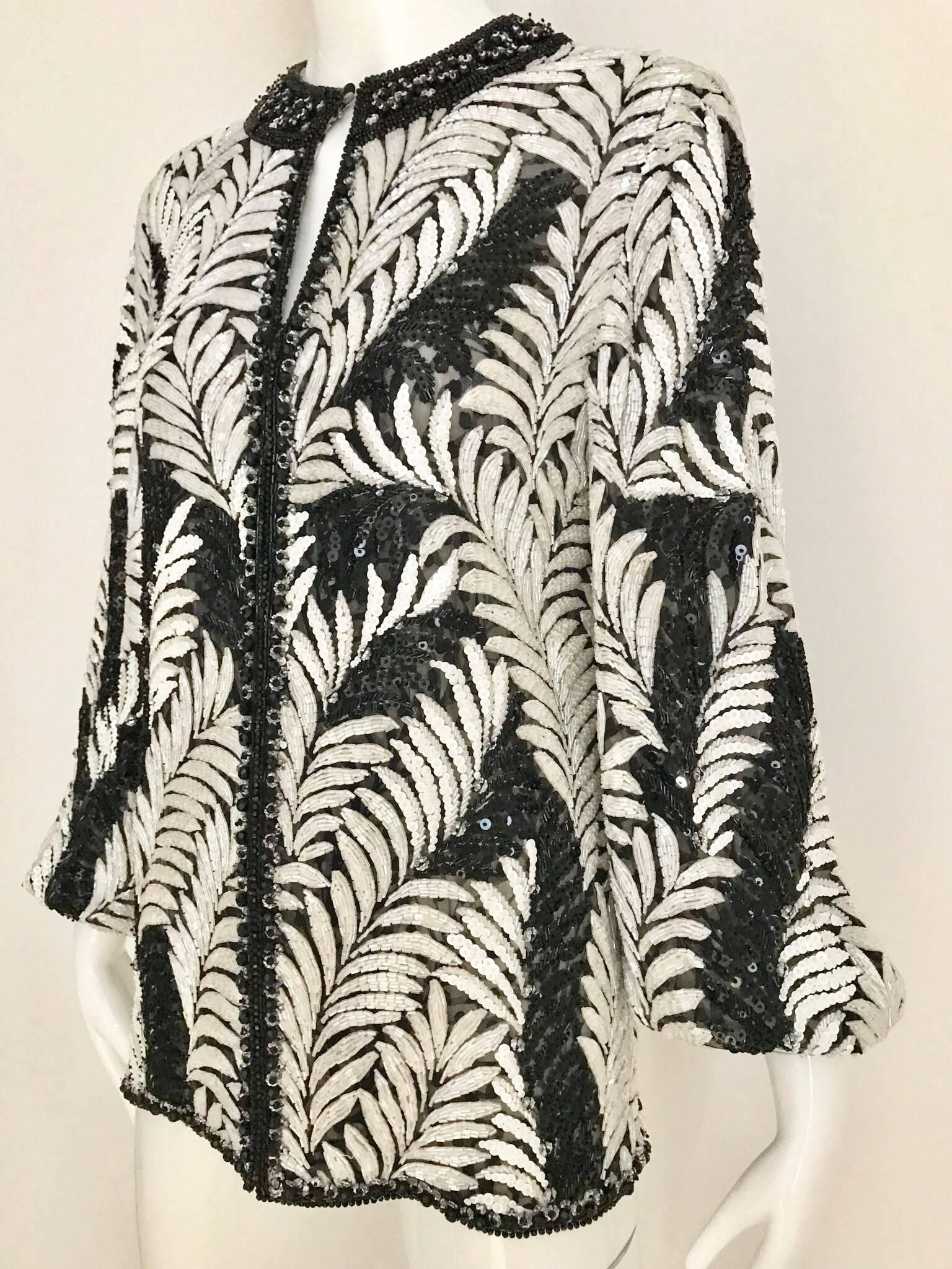 Late 80s James GALANOS black and white leaf motif beaded bomber jacket. Jacket is very heavy (4 lb) beautiful bugle beads. Jacket is lined in silk.  Size Medium (6)
Bust: 36.5  inches ( when jacket is zipped)
Sleeve length: 23 inches/  jacket