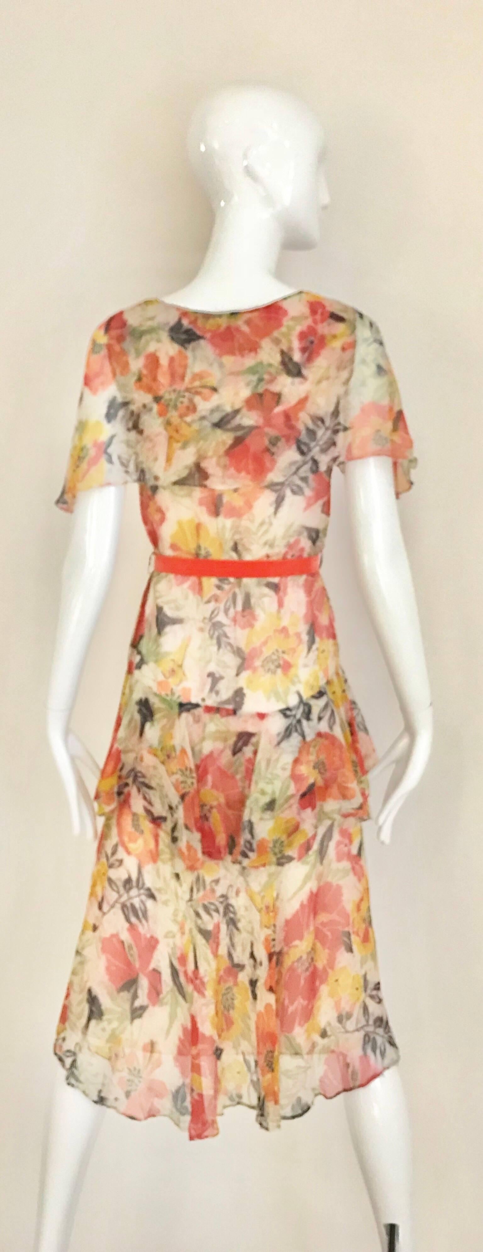 1920s floral print ( orange and yellow) silk print dress with orange velvet sash.
Fit size 0/2 XSmall. Dress is lined in cotton.
Bust: 32 inches
