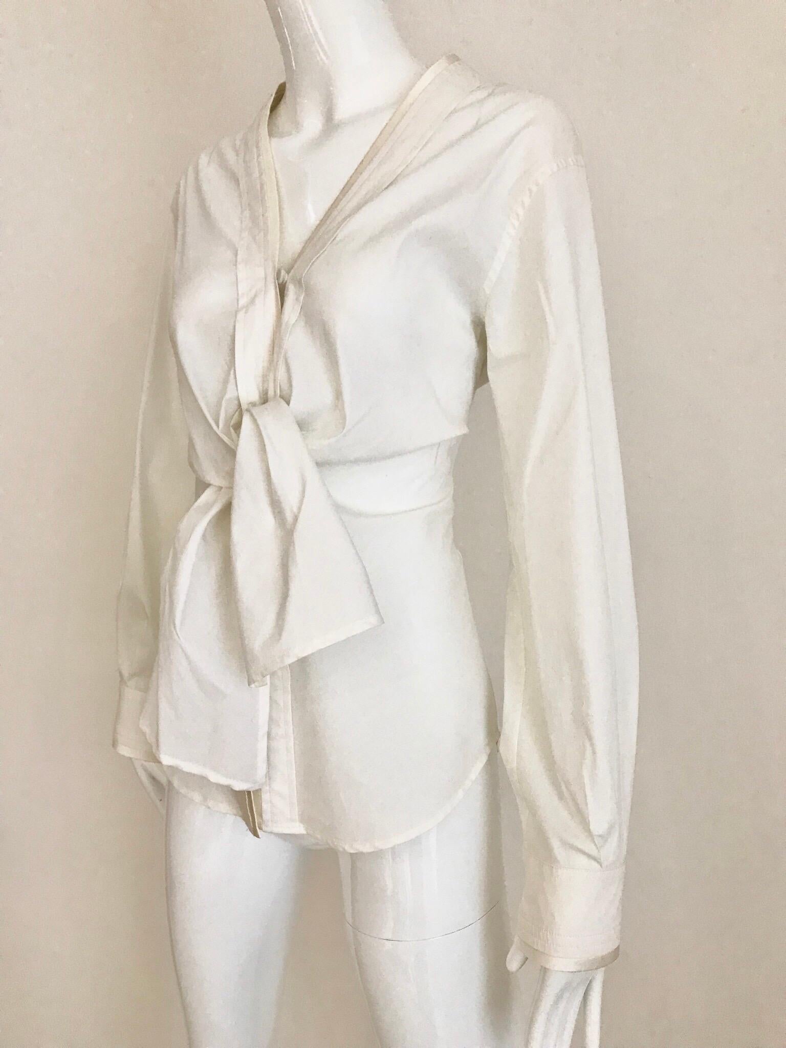 Yves Saint Laurent white creme cotton button tie front blouse designed by Tom Ford era.
Size:  Medium
Bust: 36 inches/ Waist: 32 inches/  blouse length: 27 inches
**** This Garment has been professionally Dry Cleaned and Ready to wear.


