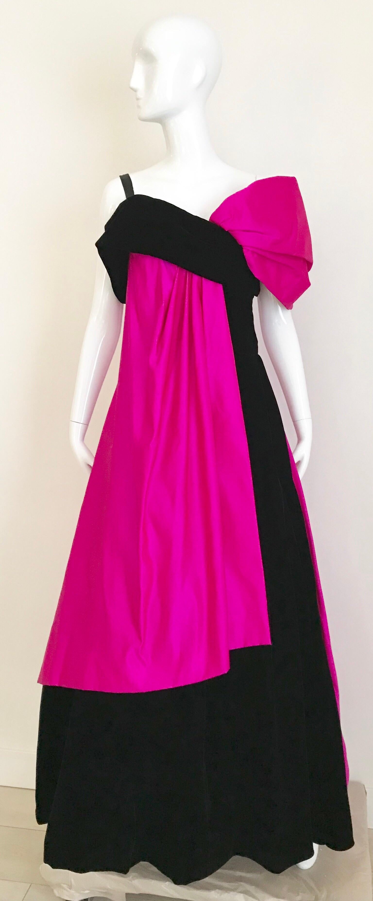 Late 80s/ early 90s Arnold Scaasi Hot pink and black velvet gown with exaggerated shoulder.
Perfect for elegant evening black tie party! Multiple layers of black tulle underneath. 
Gown is lined in silk. 
Size: Small - Medium
Measurement: Bust: 34