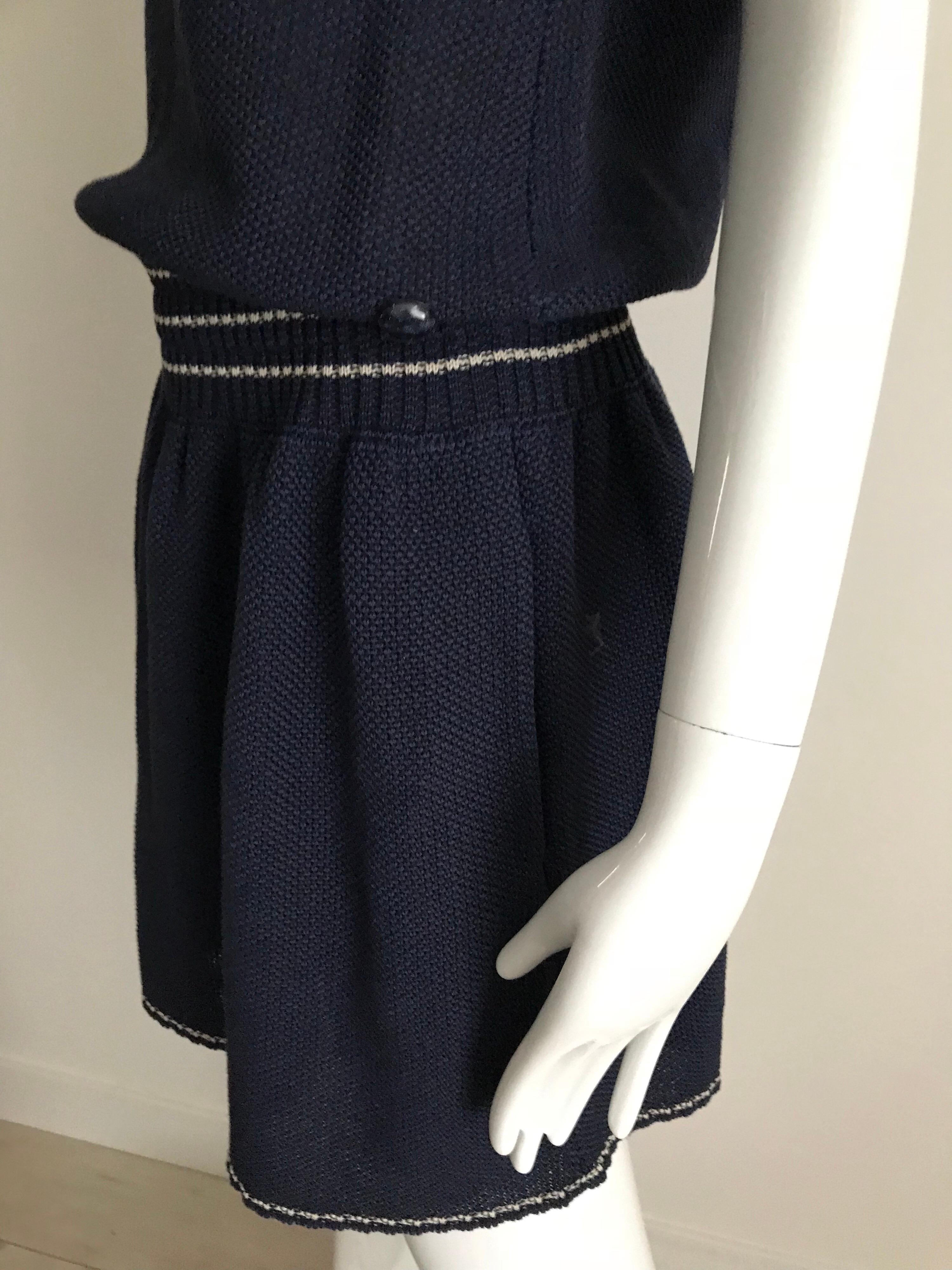 Chanel sleeveless Navy blue knit dress with blue and white piping tassel on the sleeve and collar. Fun casual attire.  Marked size: 42F/ Medium
Bust: 36-38 inches  
