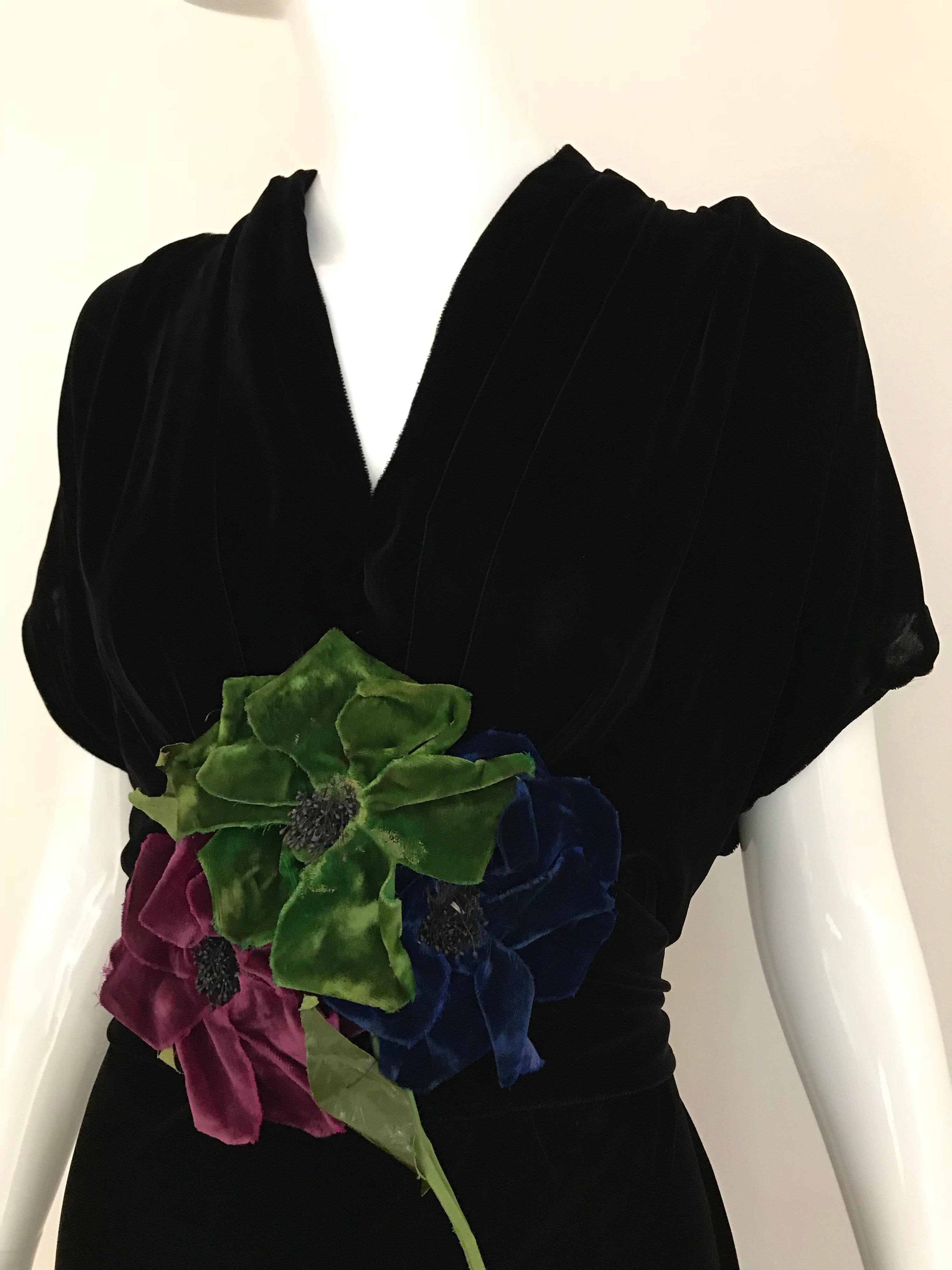Elegant larger size 30s black velvet gown with floral applique.
Size: Large
Bust: 40