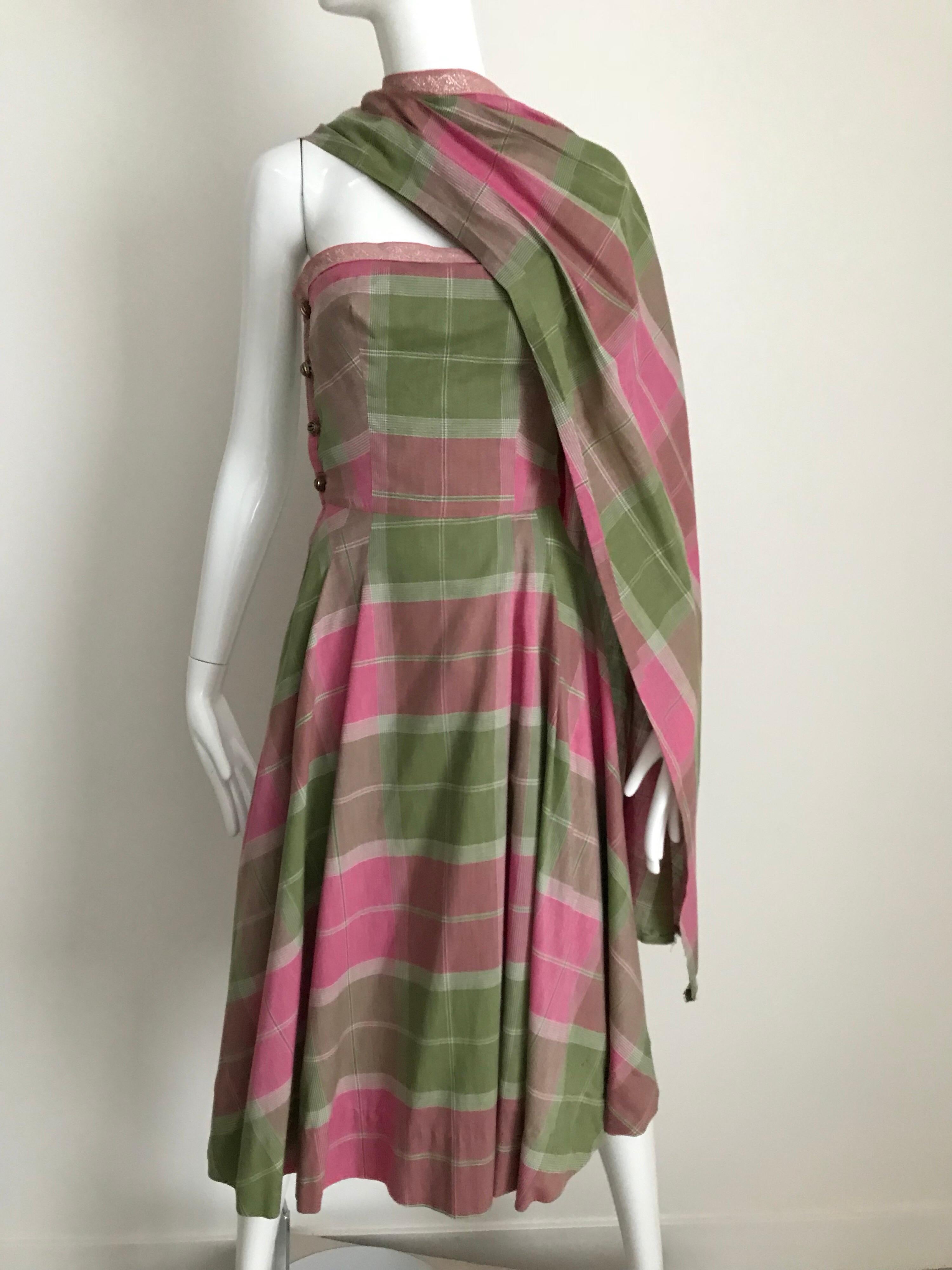1950s Tina Lesser pink and green plaid cotton strapless dress with shawl attached.
Bust: 36 inches/ Waist: 27 inches.
Belt sold separately
**** This Garment has been professionally Dry Cleaned and Ready to wear.