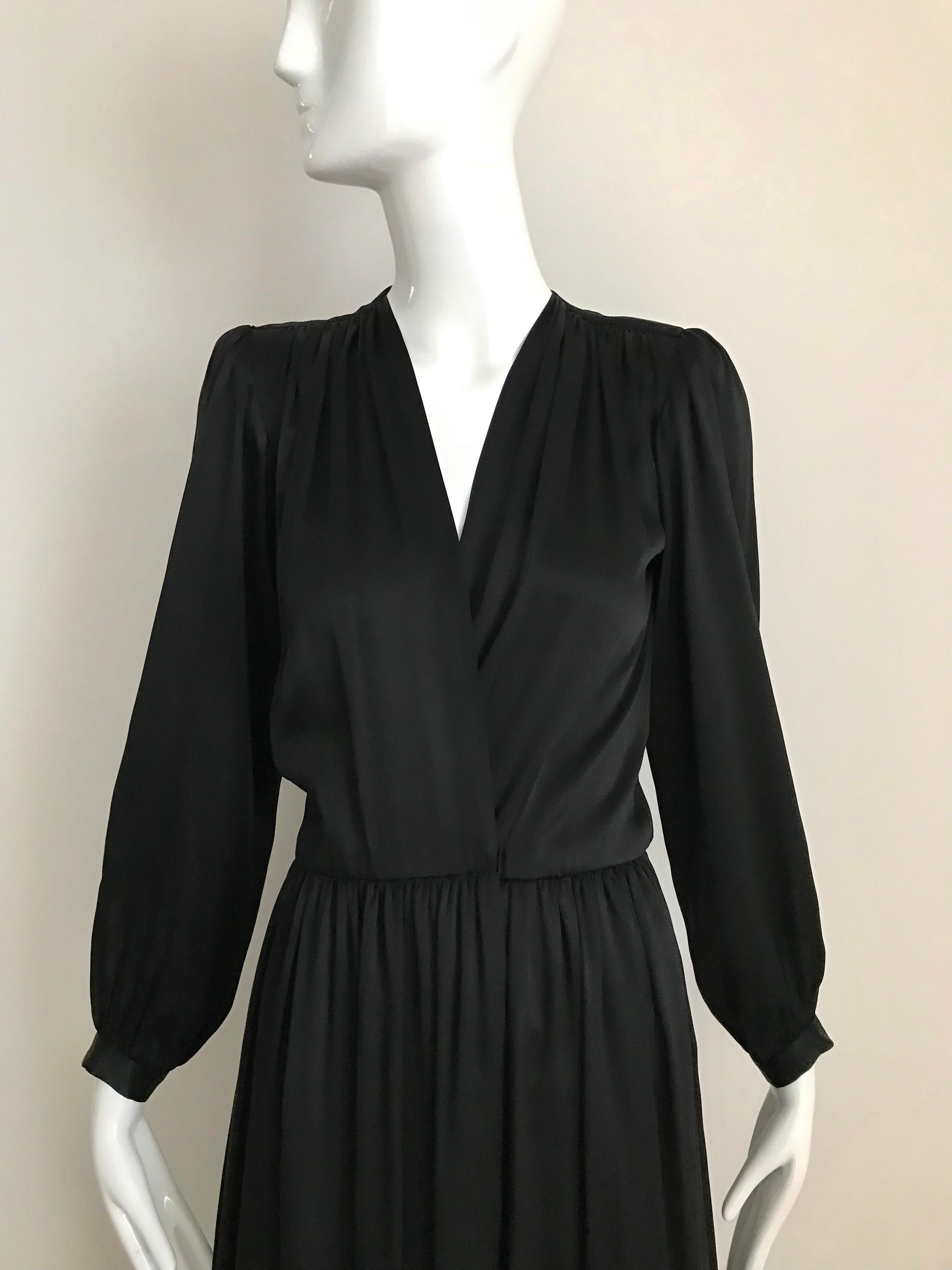 Elegant and classic 1970s Saint Laurent by Yves Saint Laurent Satin Charmeuse long sleeve V neck wrap cocktail  dress.  
Size:  Small. Label marked size: 34
Bust: 36 inches/ Waist: 27 inches/ Dress length: 56 inches