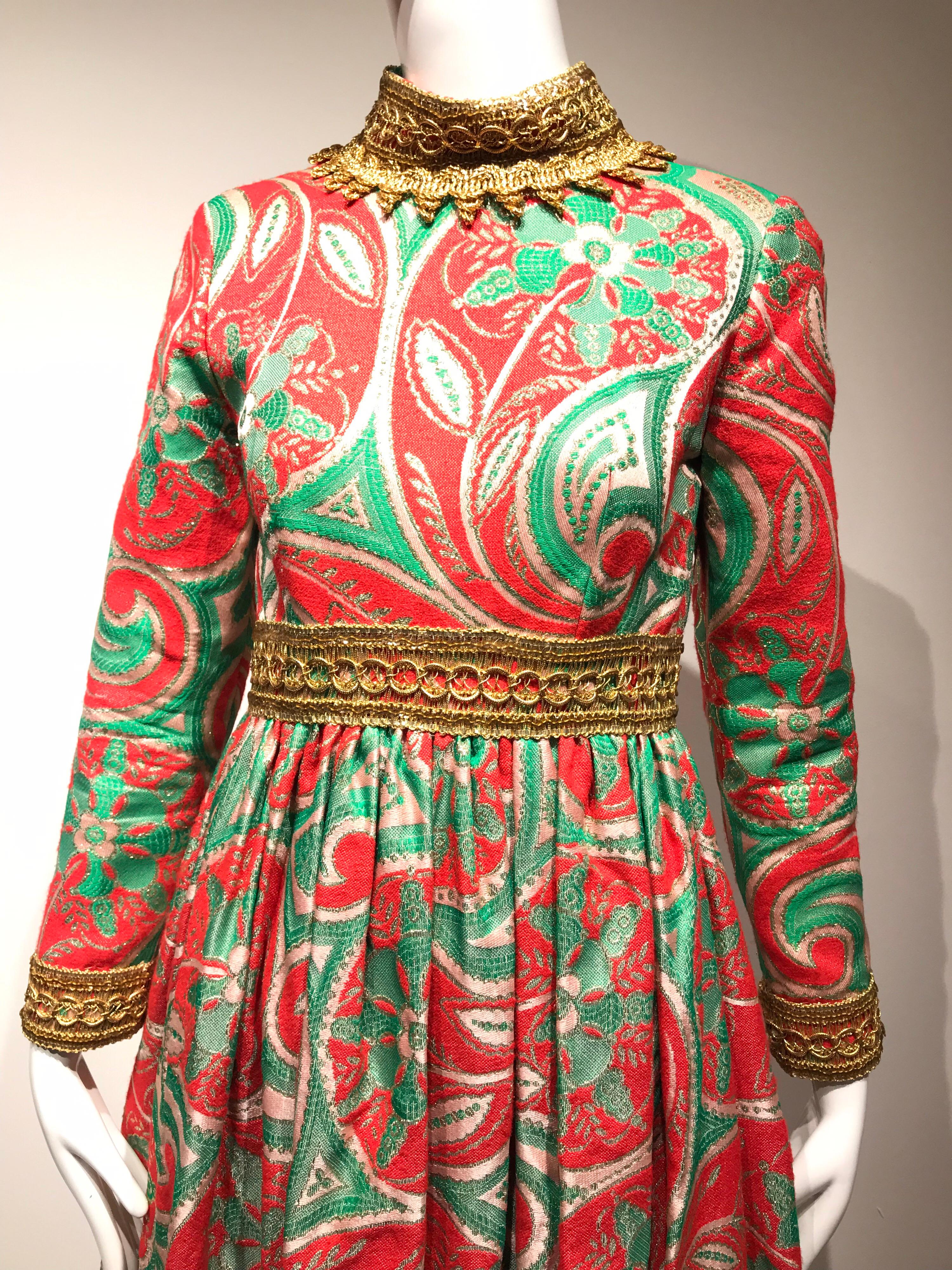 Late 60s Fun Holiday theme Oscar De La renta red, green and metallic gold silk brocade long sleeve dress. Perfect for Christmas Eve!  
Size: Small ( 2/4)
Bust; 34 inches/ Rib cage: 30 / Waist: 27”
Dress length:  51.5. And there is additional 4”