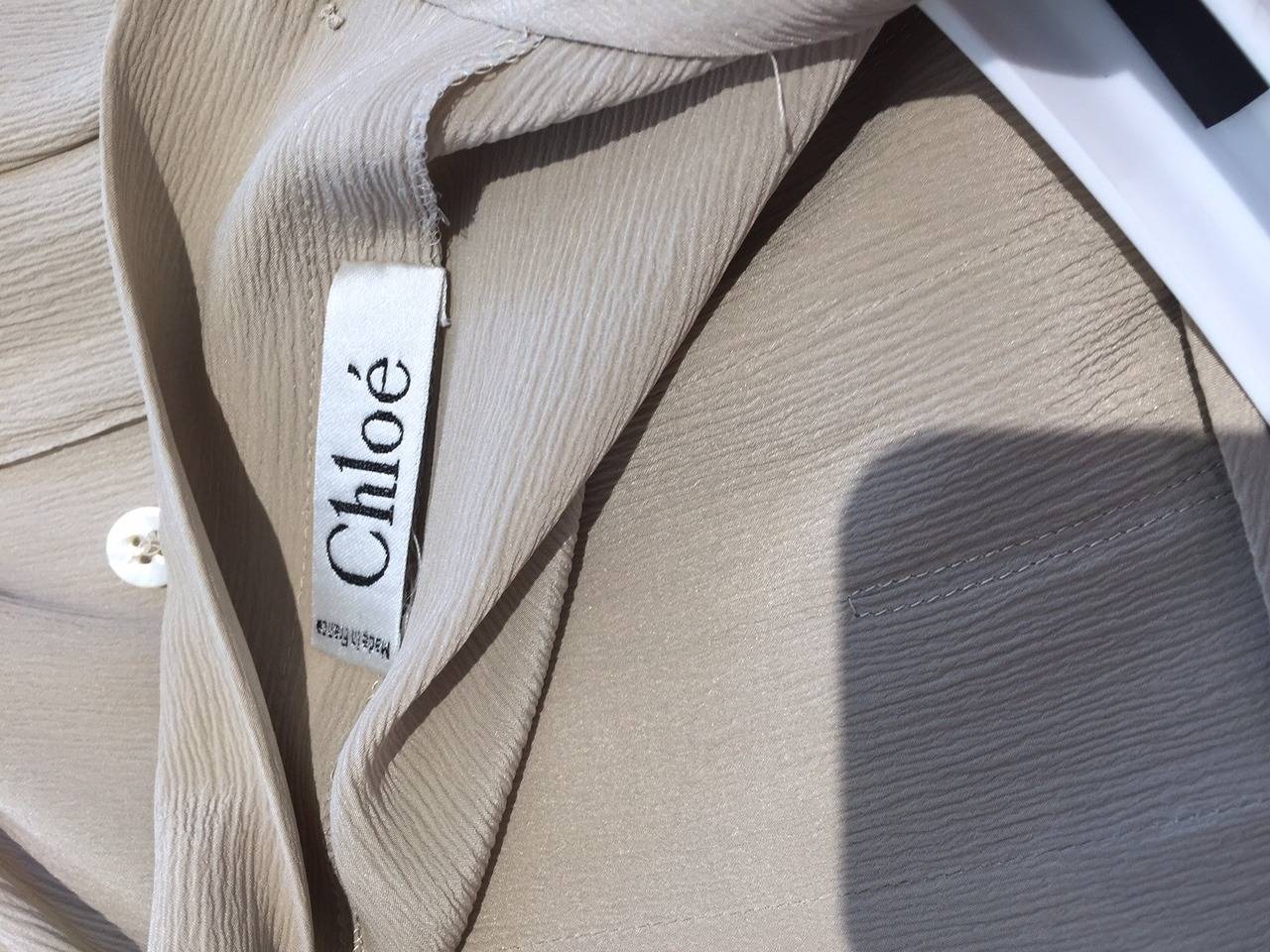 It is clear that Karl Lagerfeld was referencing a 1930s Chanel silhouette when he designed this dress for Chloe. Its cream and black butterfly sleeves, loose, paneled bodice, and neat pleats that open just above the knee all recall the innovations