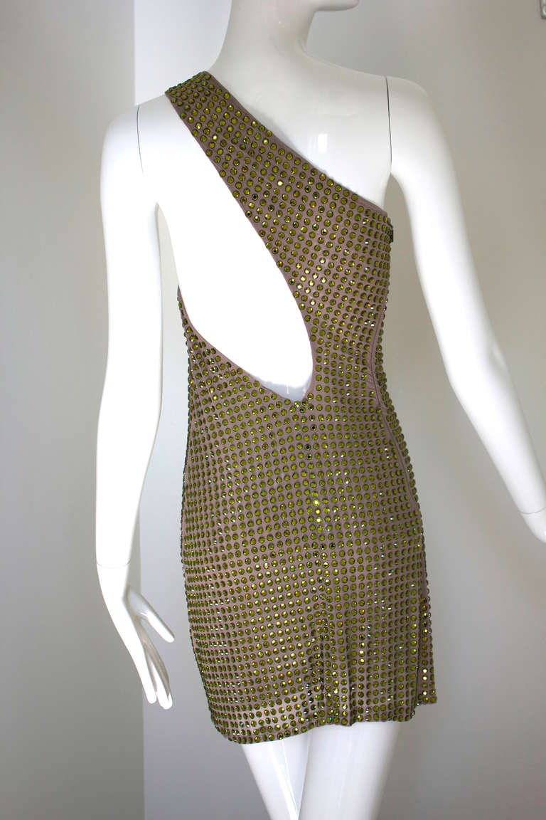 Tom Ford single handedly brought Sexy back to Gucci when he took over in 1994. This spring/summer 2000 collection Gucci mini dress is a real stunner and shows the Ford touch. With a strap at one shoulder, it is completely covered in acid green