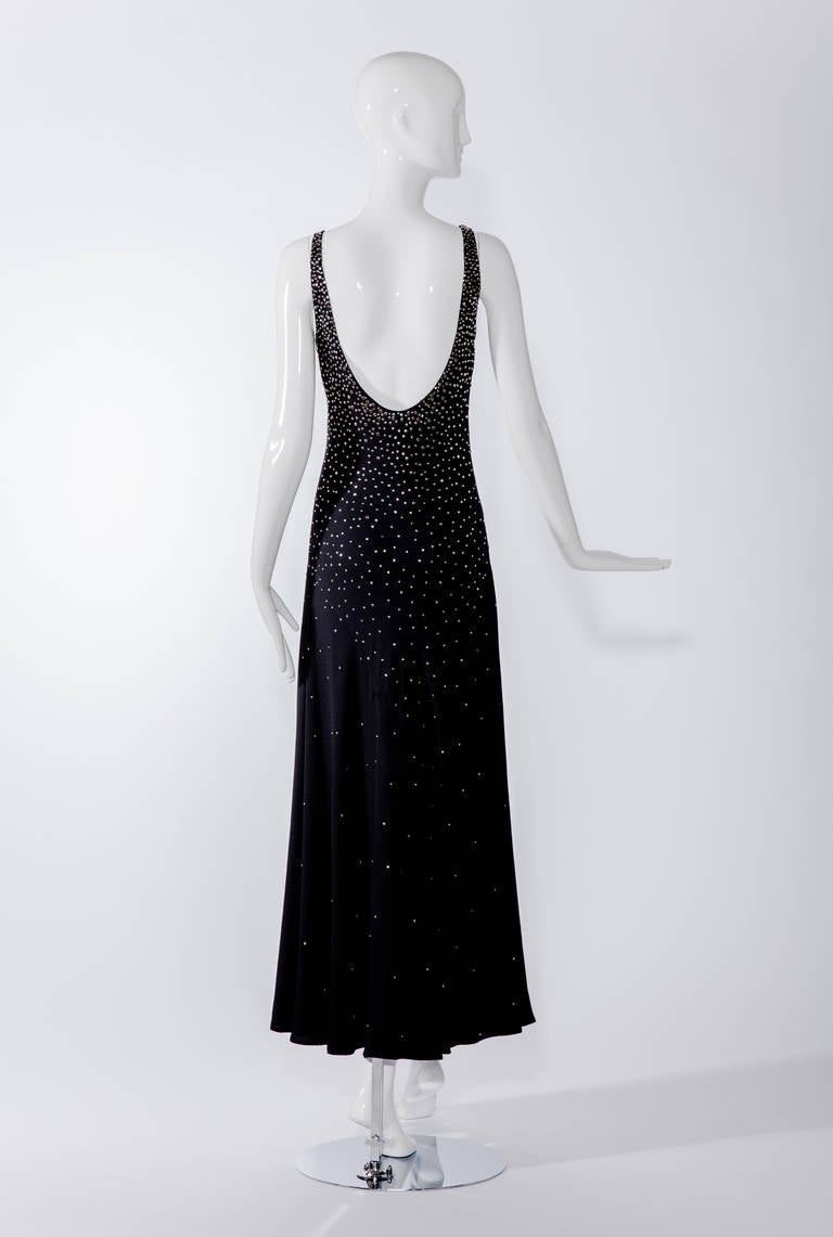 C.1970s HALSTON black crepe bias cut studded dress. Dress has metal studs.

condition : Great. missing one stud at the back (lower)

Size : 2-4 Small