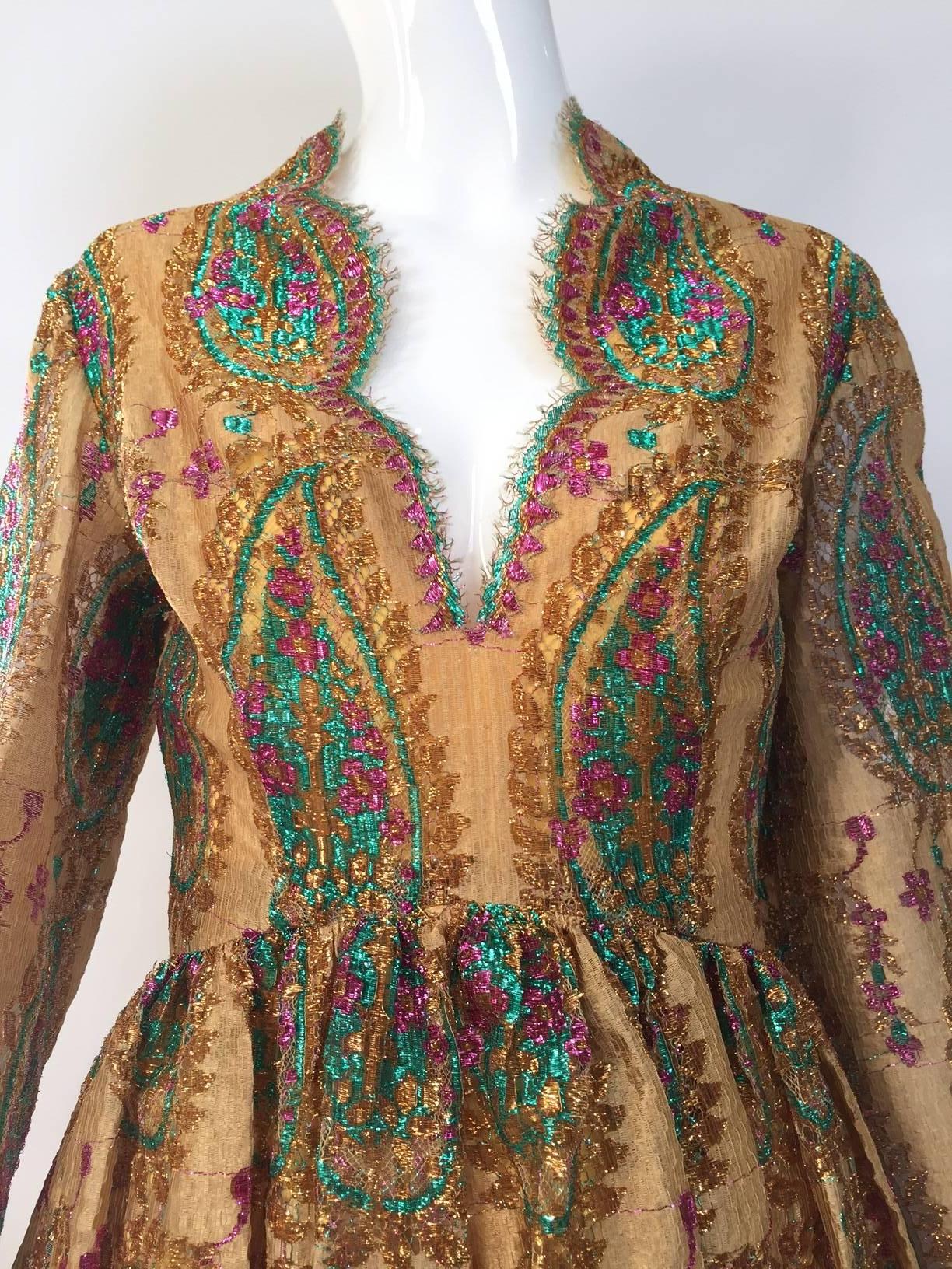 Documented 1968 Bill Blass  gold lace dress. (see editorial images from vogue uk 1968)
 Paisley print green and fuschia metallic thread woven onto the lace.

Bust : 34
Waist : 27