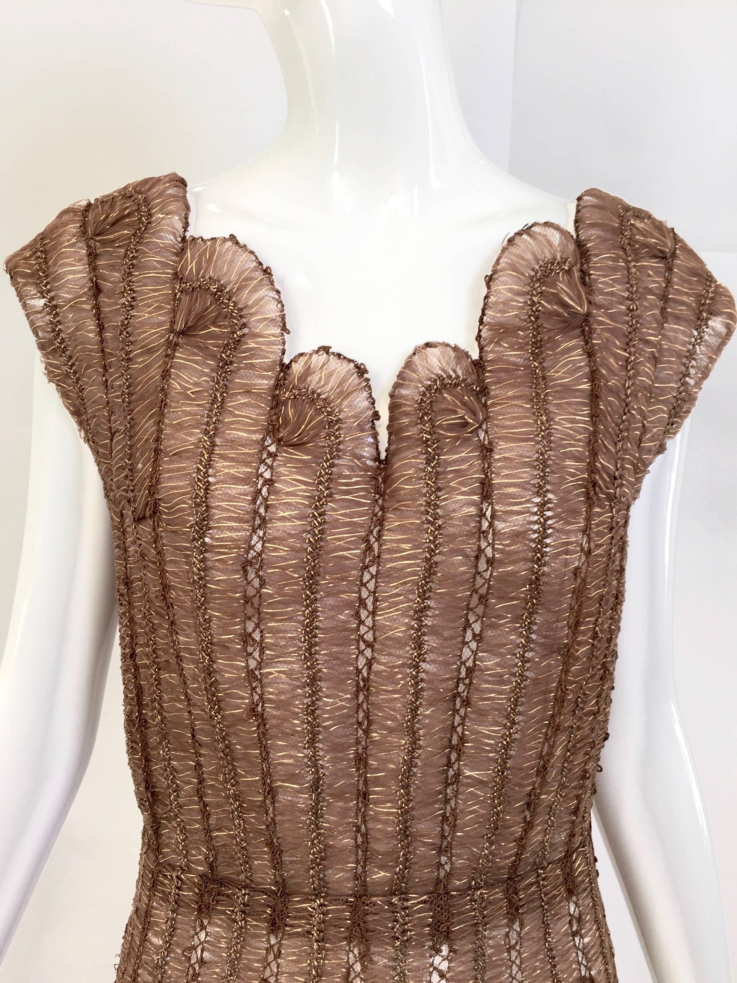 Beautiful 1950s metallic brown  custom made cocktail dress. Woven silk ribbon in brown and gold color. Cap sleeve and sweet heart neckline. A line skirt. Classic 1950s dress. Medium / Size 6
Bust : 36 (fit C cup)
Waist: 28"
Length:
