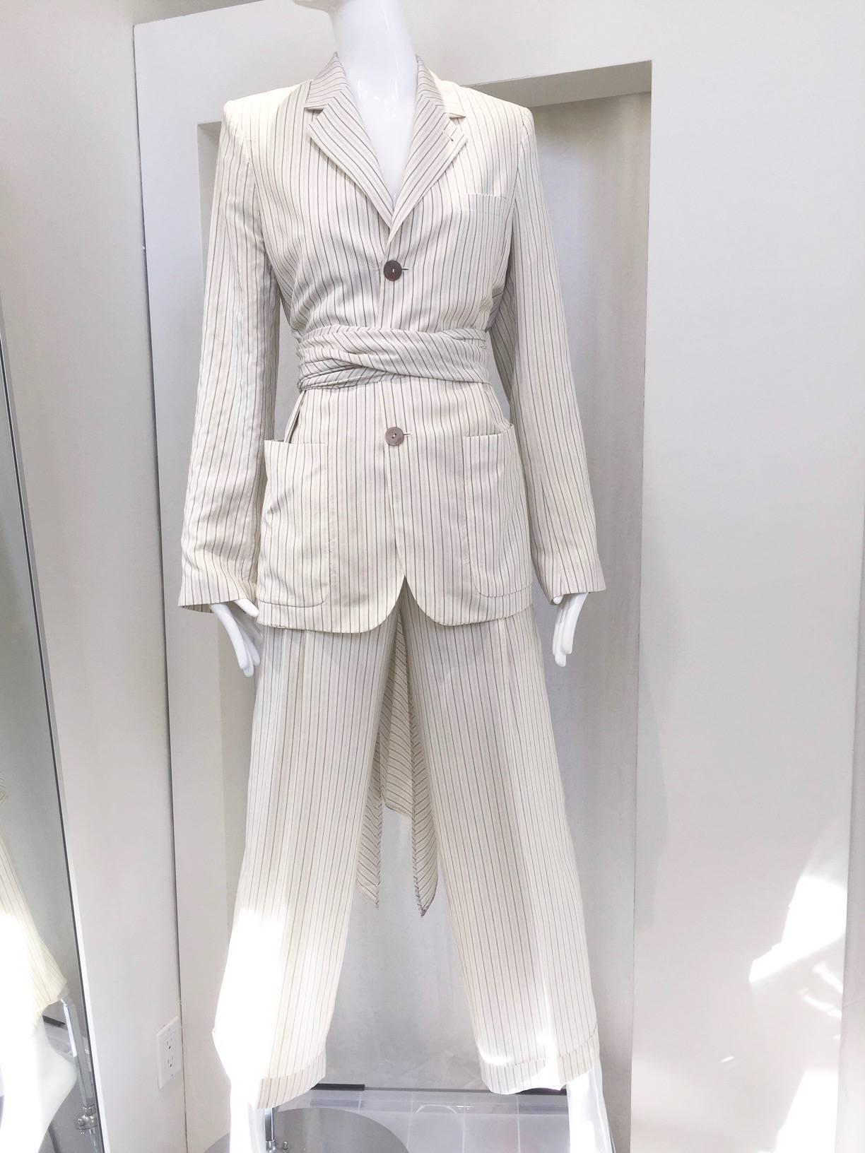 1980s Jean Paul Gaultier creme pin stripe silk blazer pants set.
open back, with silk sash wrap around the waist.
Marked size 10 but it fit size 6.

Measurement for Blazer:
Shoulder: 15