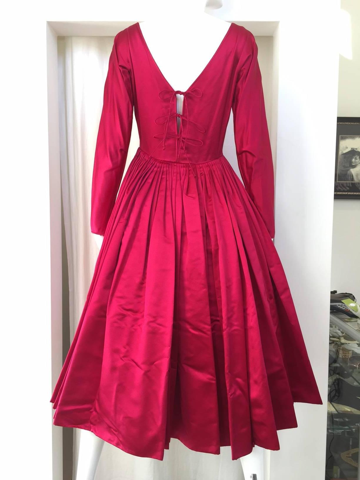 Vintage 1950s Galanos magenta red silk cocktail dress. Dress has Silk Button and matching Belt, nipped in the waist. 
 This Dress remind me of Vintage 1950s Dior Couture - The New look!   This dress comes with crinolin.
Size: SMALL - 2/4
 /Bust: 34