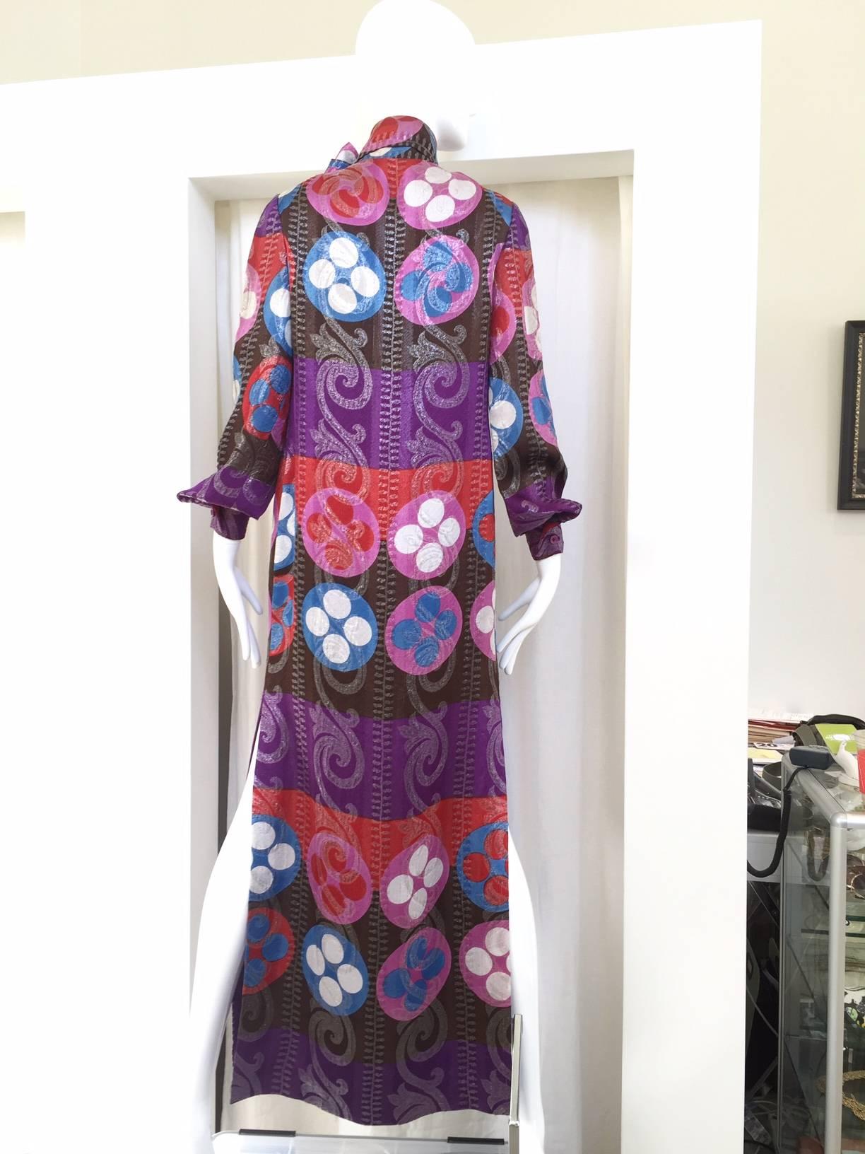This 70s Lanvin silk kaftan gives the eye a gorgeous palate of color.  Purple, pink, red, blue, white and brown are mixed exquisitely in a geometric print, embellished with swirls of silver lurex thread that sparkles and softens the geometric