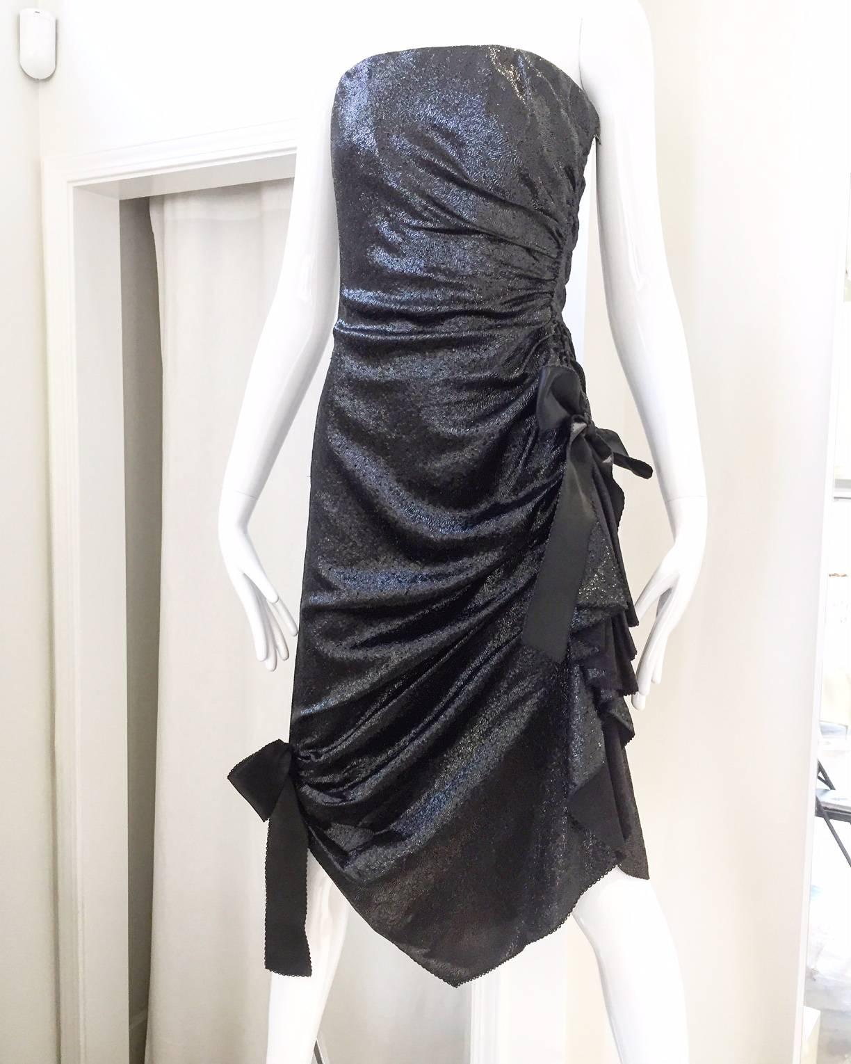 What a fun and Flattering  sexy party dress from 1980S  Elizabeth Arden salon. Beautiful black shimmery fabric featuring bow on side.  Perfect Cocktail Party Dress.
Fit US 2 / XSMALL
Bust: 32"/ Waist: 24" /Hip: 34" / Length: 44"/