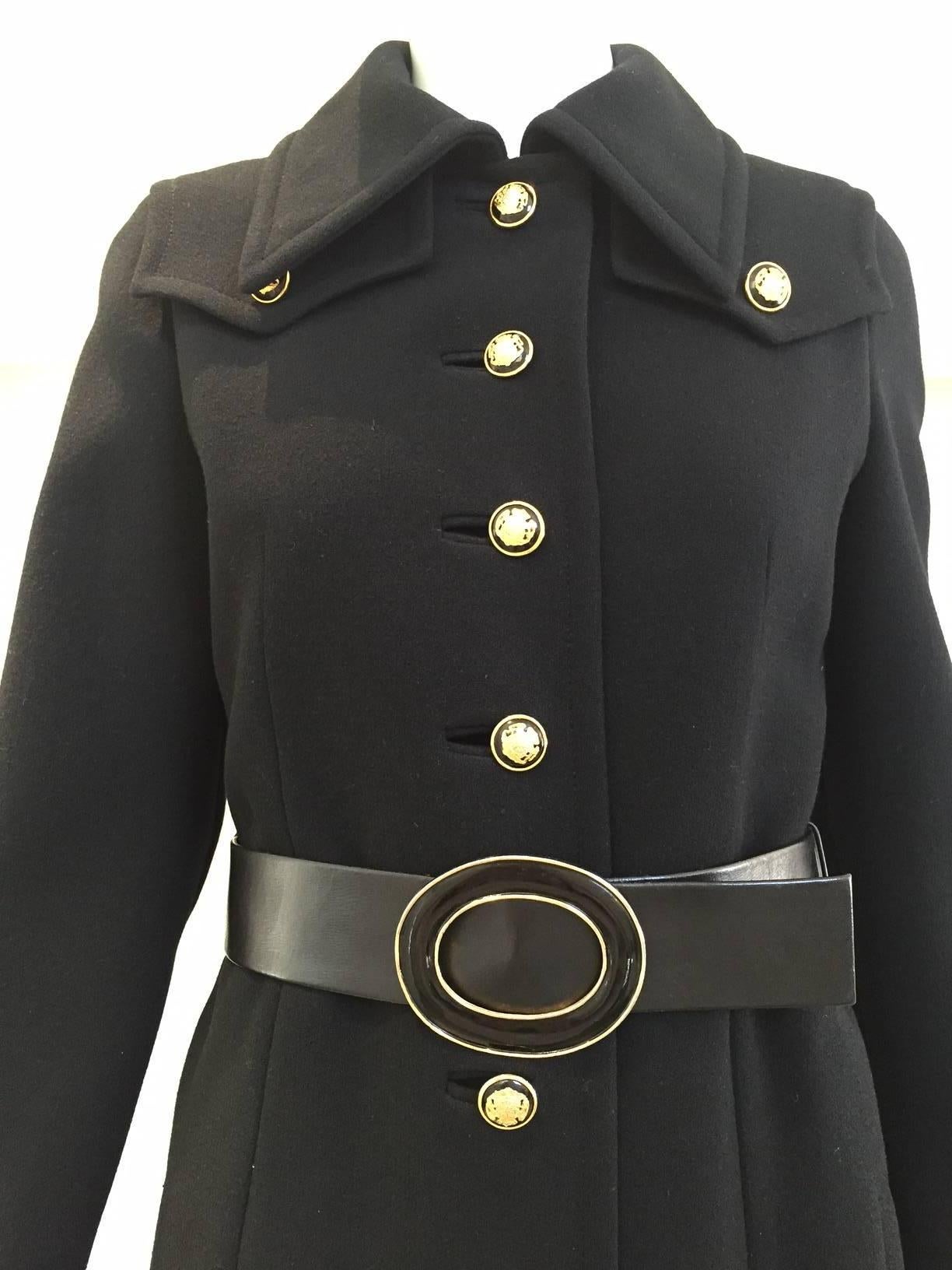 1970s black Bonwit Teller wool crepe pea coat with black and gold metal crest button. ( belt - side pockets).  size: 2 or 4 max.
Bust: 34