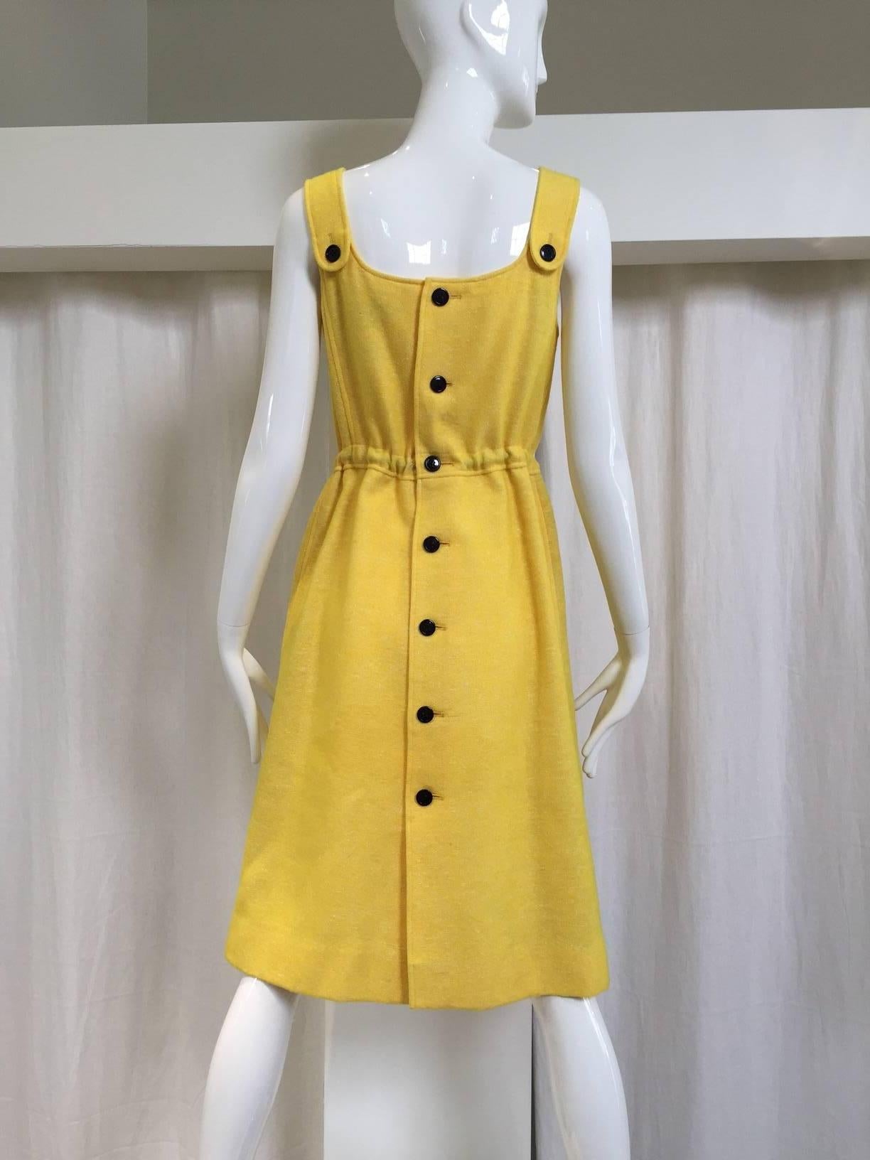 1960s Courreges yellow wool dress with adjustable drawstring waist and 2 pockets. Button all the way at the back. 
Dress is lined.
Small. Fit size 4
Bust: 32"/ Waist: 26" / Hip: 38" /  Length: 40"