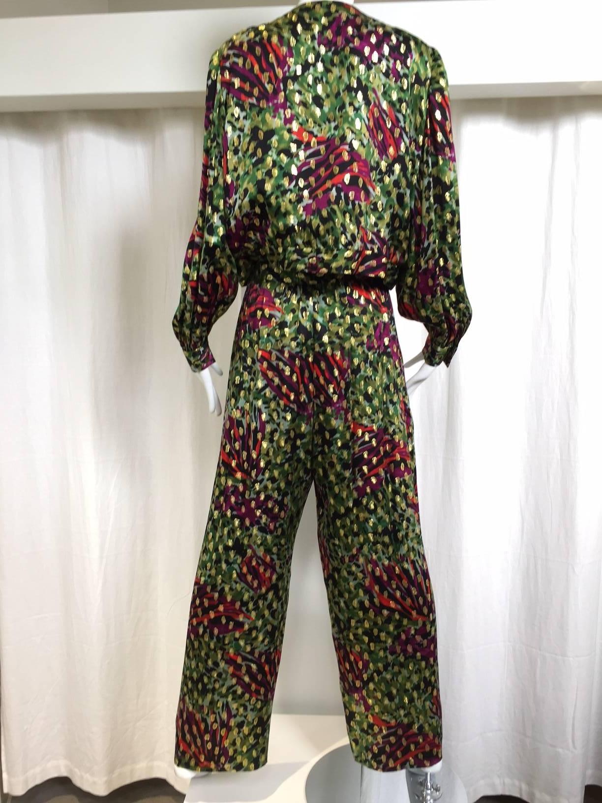 1980s Givenchy Silk lame jacket/blouse in green, gold, red and fuschia print.
You can wear it as a blouse by moving the hook and eye on the jacket. ( see image) 
Jacket/ blouse : 46
