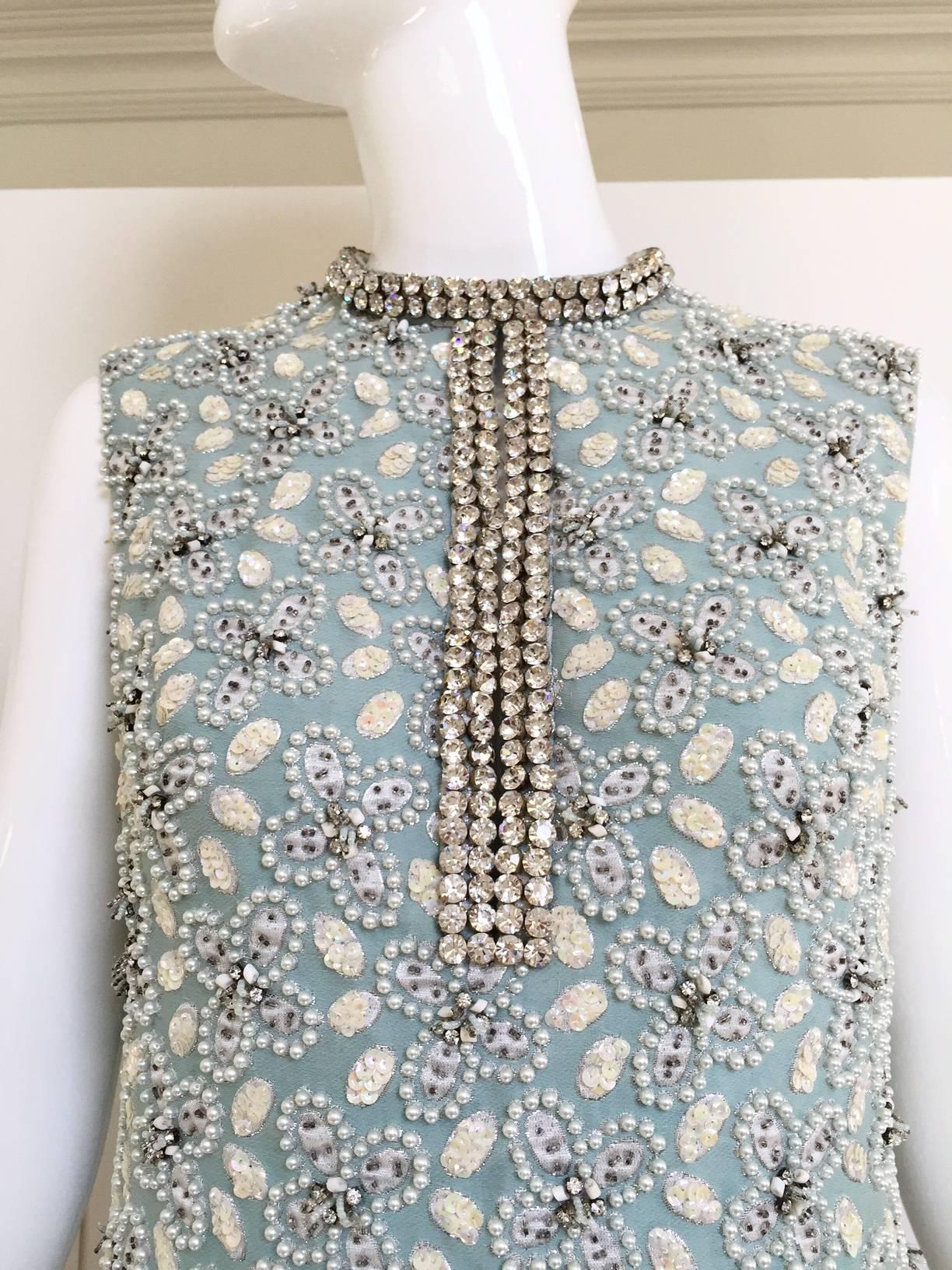 Incredible vintage 1960s light blue heavy cotton beaded gown with white small clustered pearl  and rhinestones collar. Chic and timeless Cocktail gown.
Bust: 36"/ Waist: 33" /Hips: 38"/ Length: 54"
Size: Medium