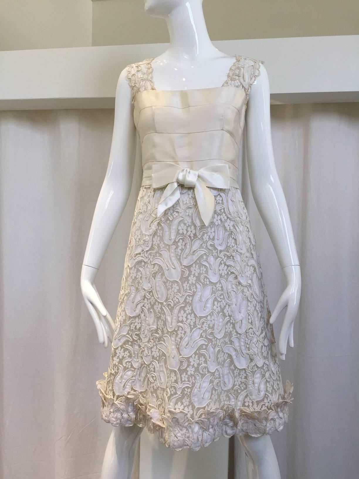 This exceptionally detailed ensemble is made of DARQUER lace custom designed for CHANEL . DARQUER is a company in Calais, France that has been producing beautiful artist designed lace since 1840. The tulip designs in the lace are accentuated with