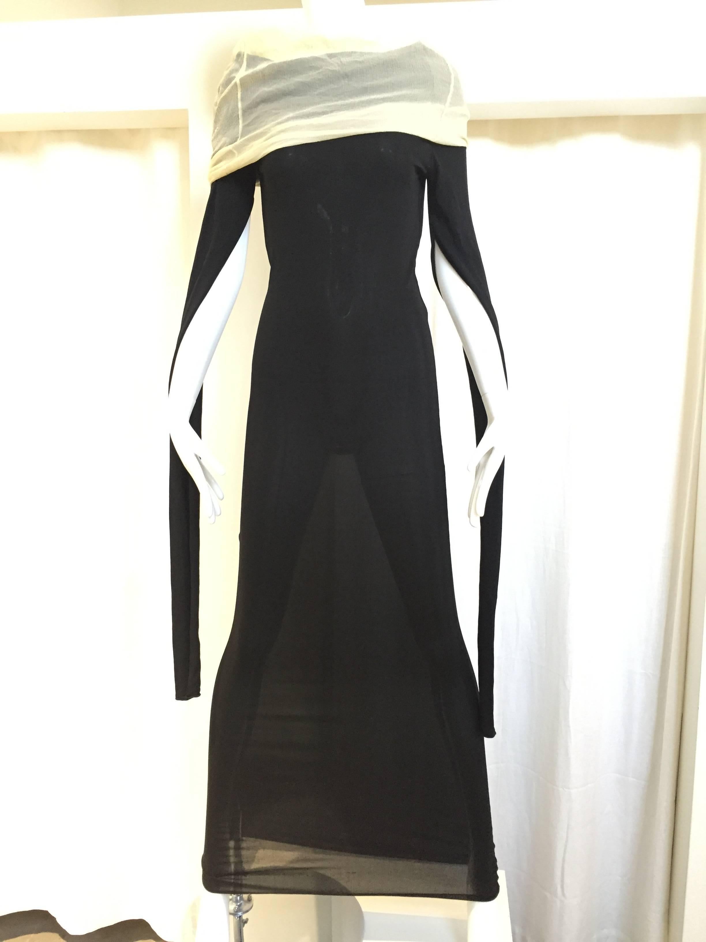 Vintage Jean Paul Gaultier black jersey knit dress with long sleeve and exaggerated collar.
 Size: 4/6 fabric is stretch. Fit small to medium.