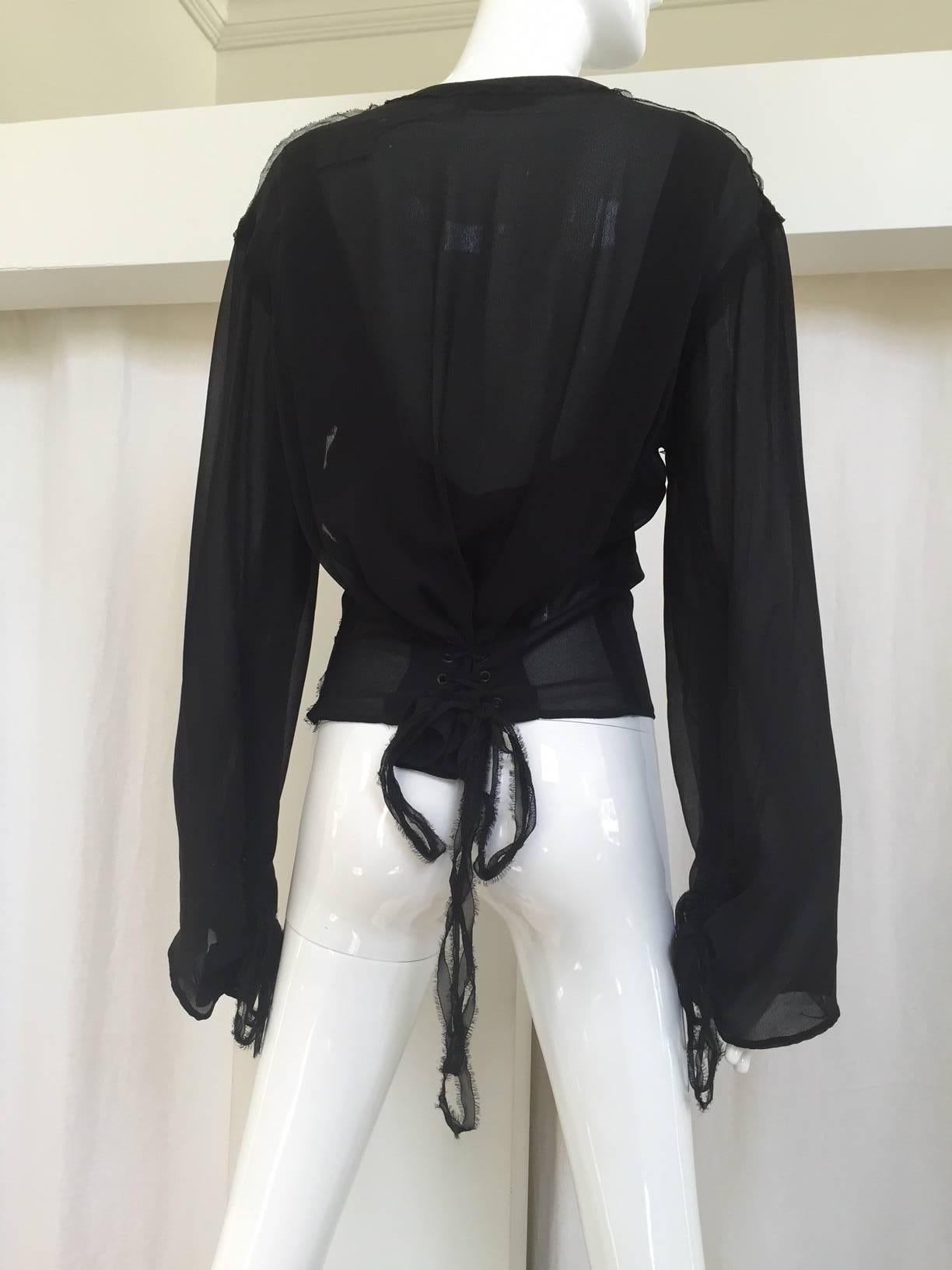 Early 2000s YSL black silk lace up blouse by Tom Ford. Marked size: 42
blouse is adjustable due to lacing in the front and back. Medium size
Measurement: 34-36