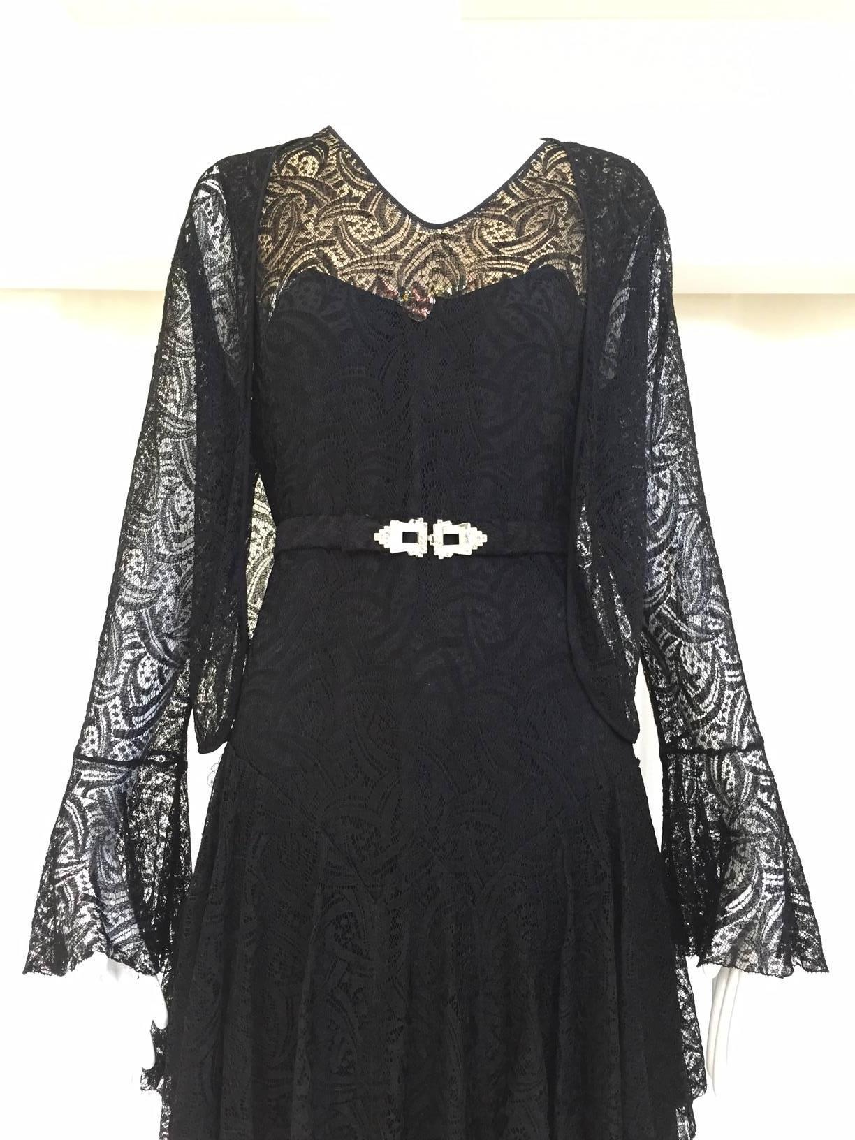 Simple 1930s black lace cocktail dress with lace cardigan jacket. Belt need new rhinestones. Snaps on the side. no zipper.  Fit size 6
Bust: 36
