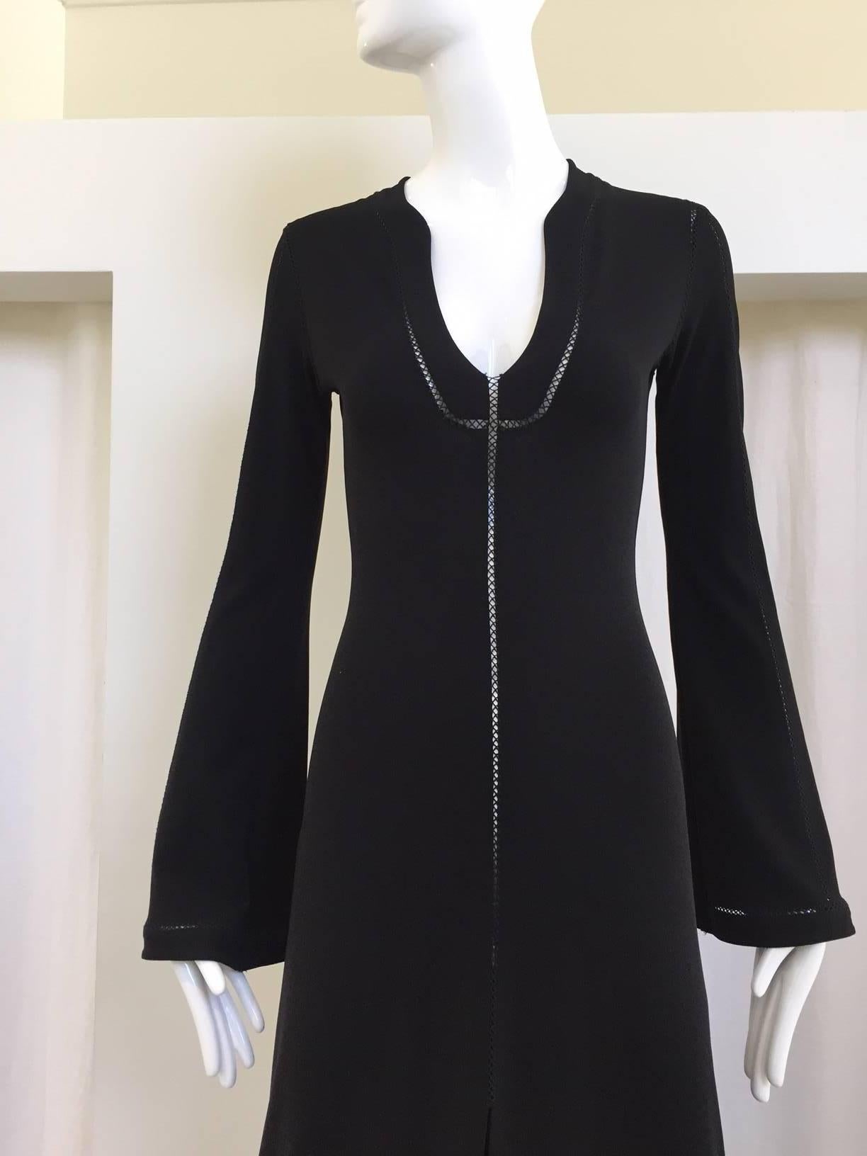 Sexy 1970s inspired plein sud black rayon jersey cut out stitch dress. 
Front slit and cut out stitch all over the sleeve, front and back. Sexy and chic.
Size: Small - 4
Bust: 32